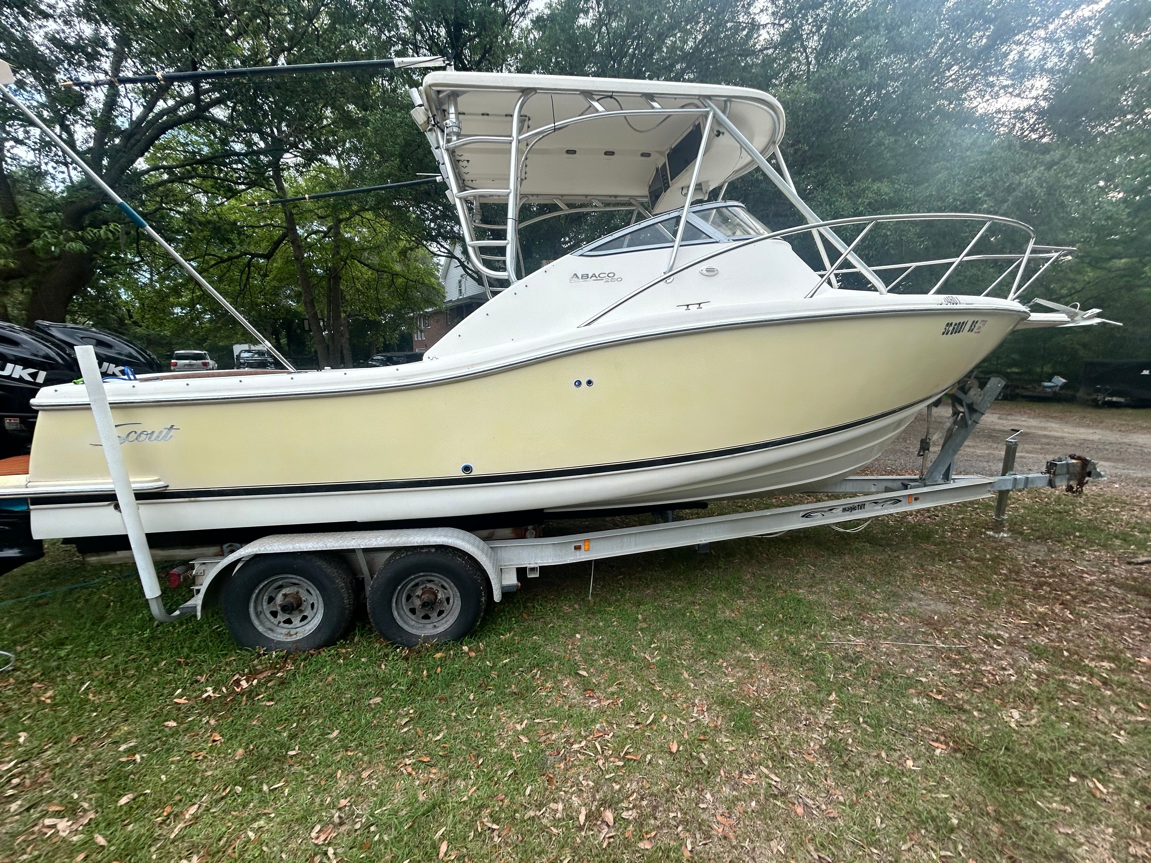 2003 Scout 280 Abaco on a trailer, surrounded by trees.