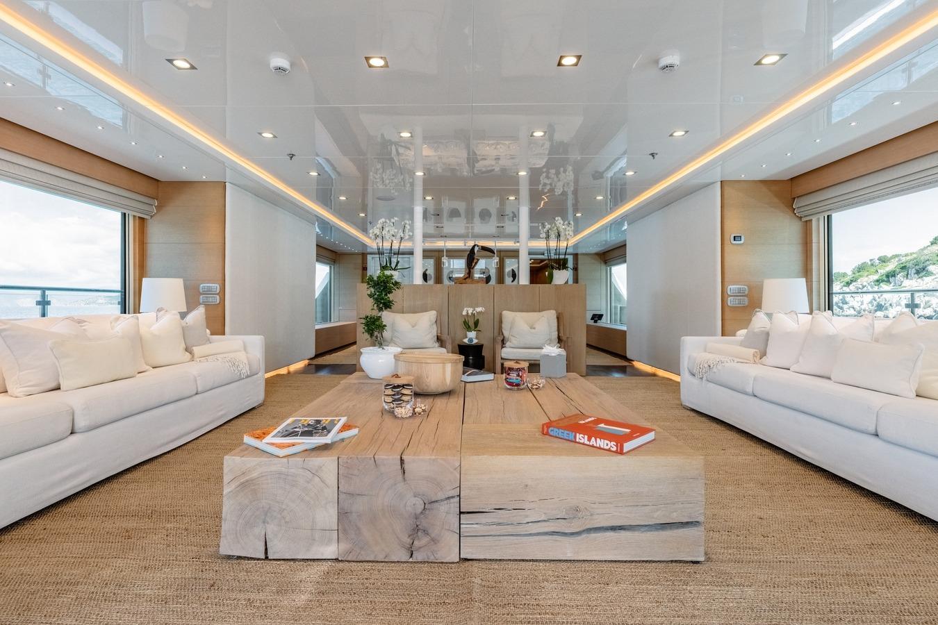 Luxurious yacht interior by Ortona Navi, 2008, featuring elegant sofas and a wooden coffee table.