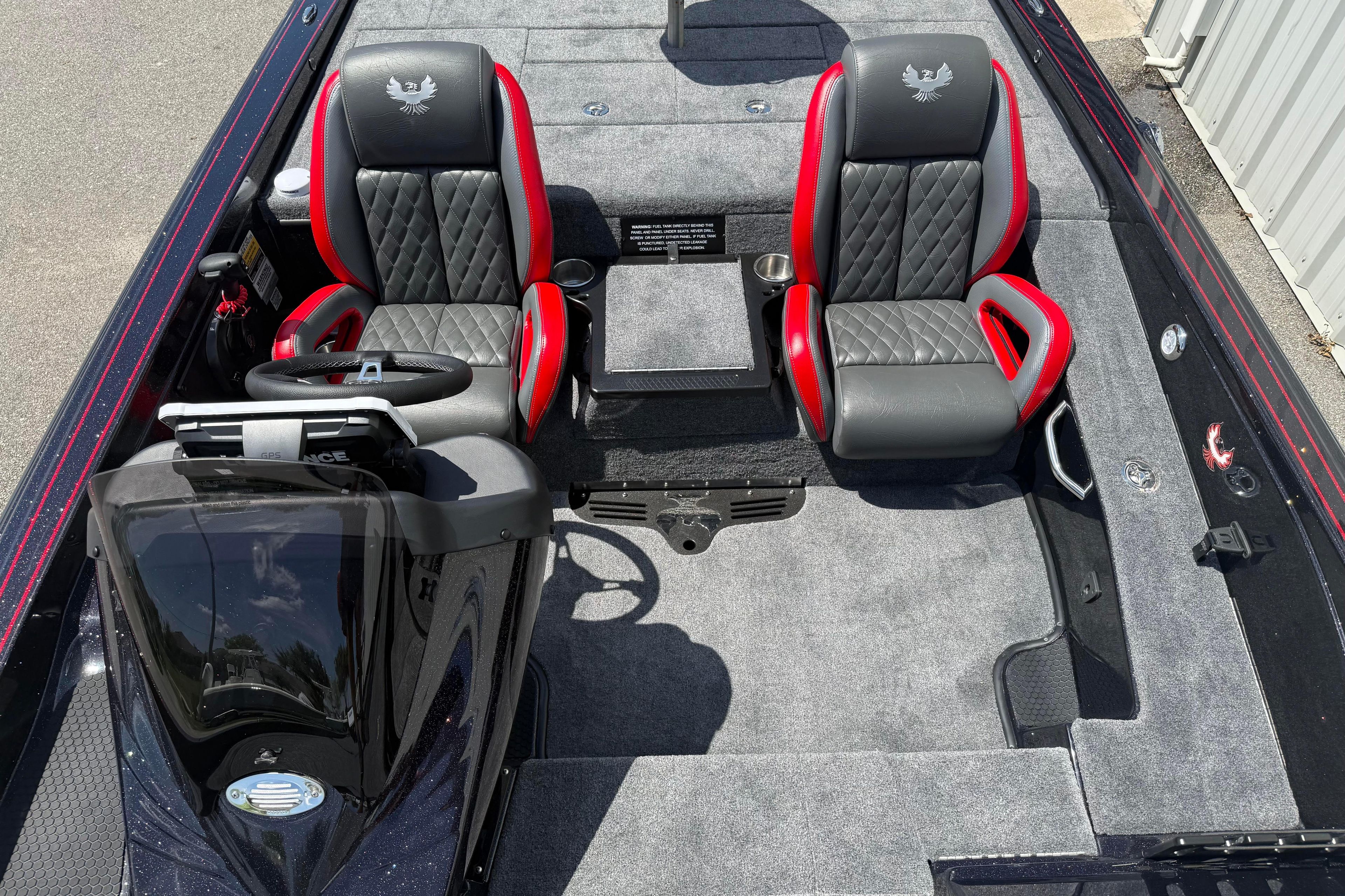 2027 Phoenix 919 ZXL boat interior with dual black and red seats, steering console.