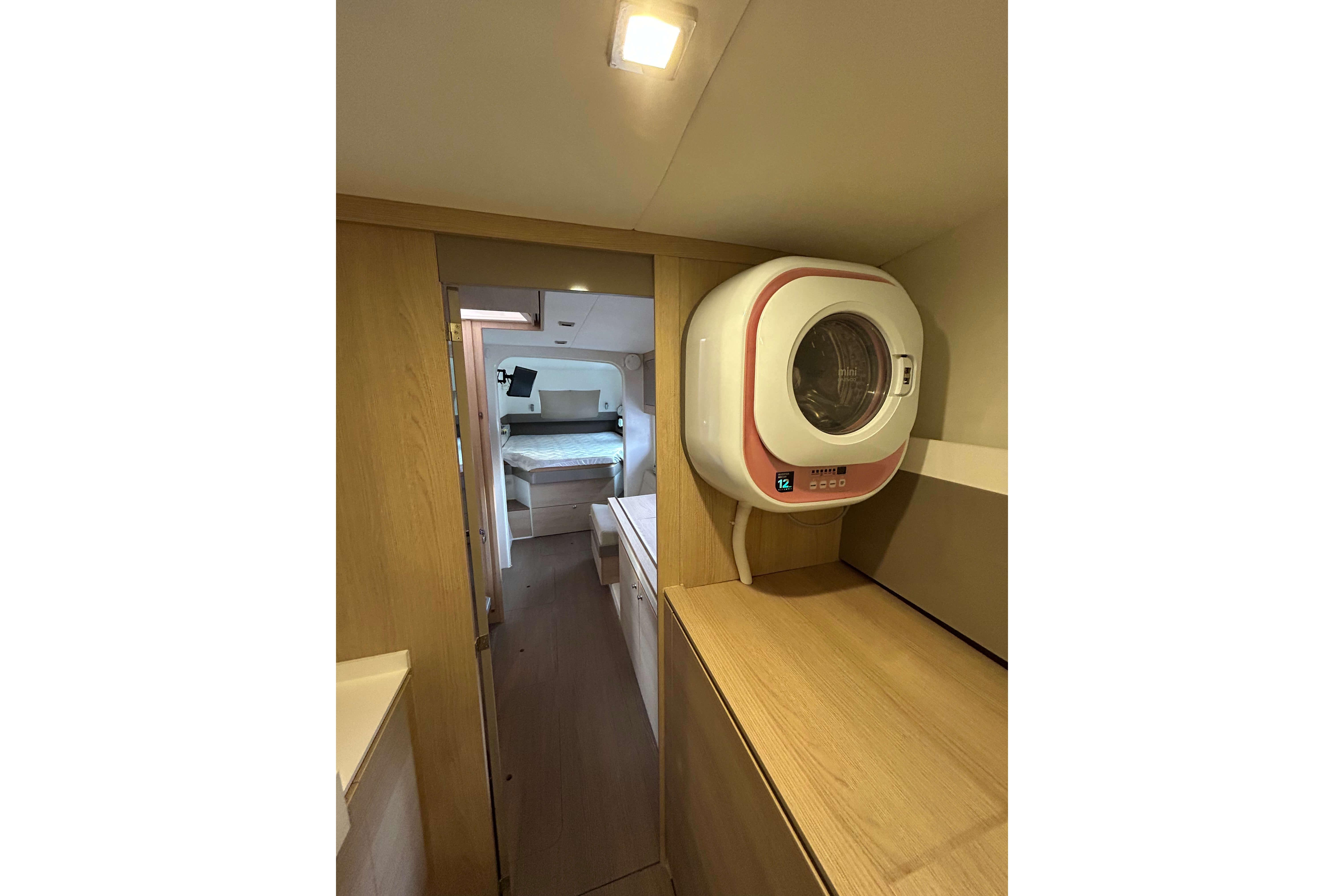 Compact laundry area in 2018 Bali 4.1 yacht interior with modern washer.