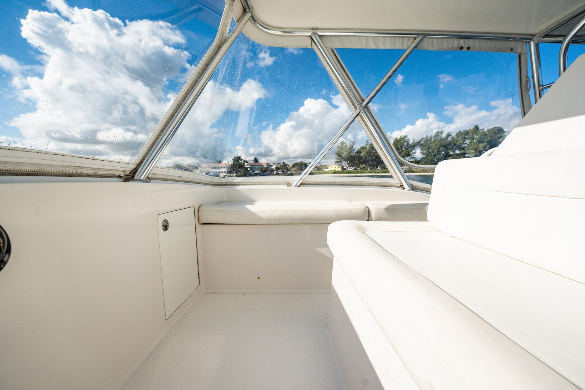 Interior view of 2007 Egg Harbor 43 SportYacht with white seating and clear windows.