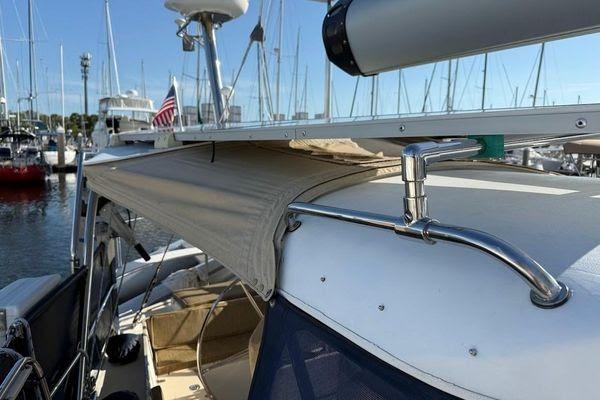 Sailboat deck with canopy, Reliance 44, 2011 model, docked at marina.