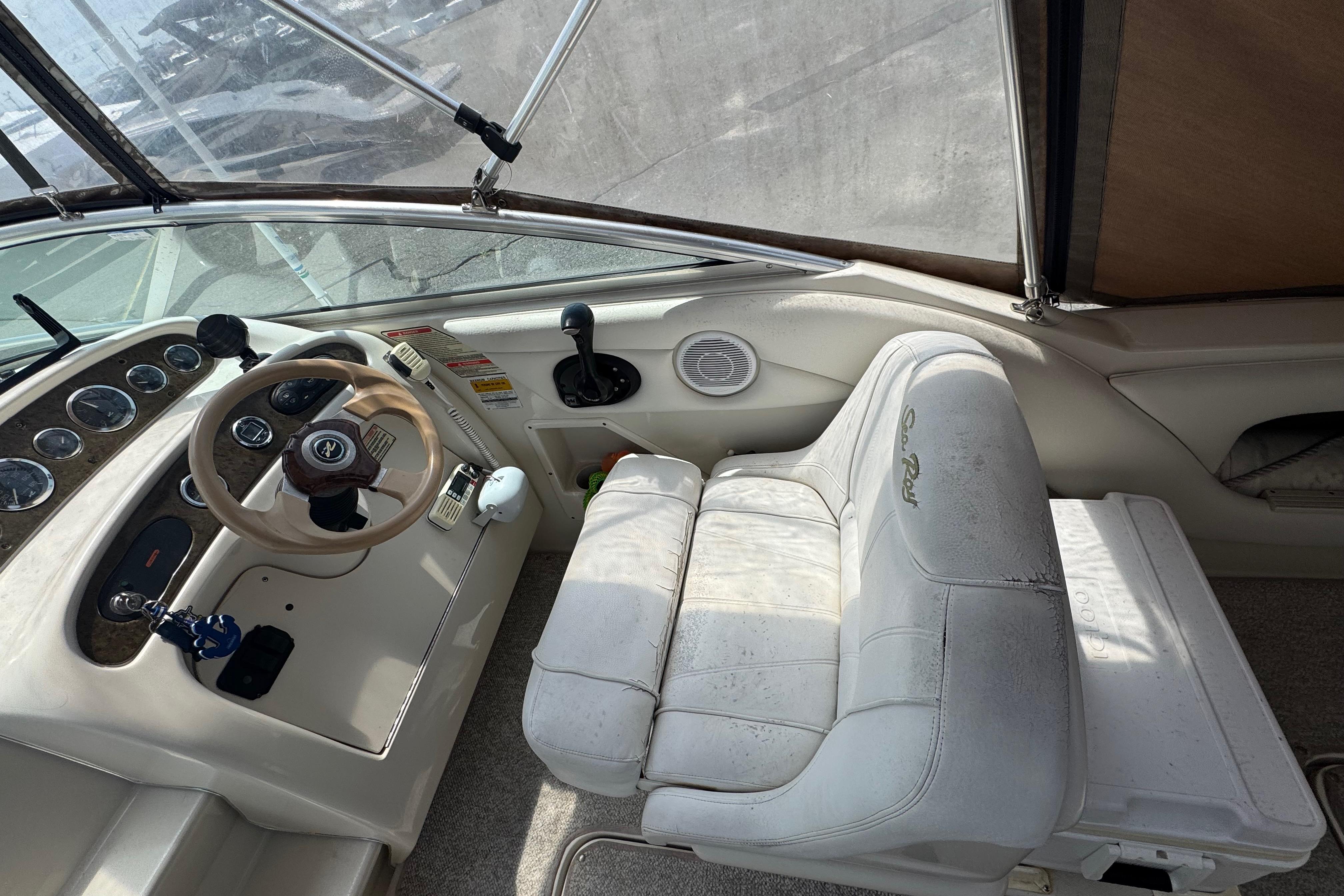 2001 Sea Ray 245 Weekender boat cockpit with steering wheel and control panel.