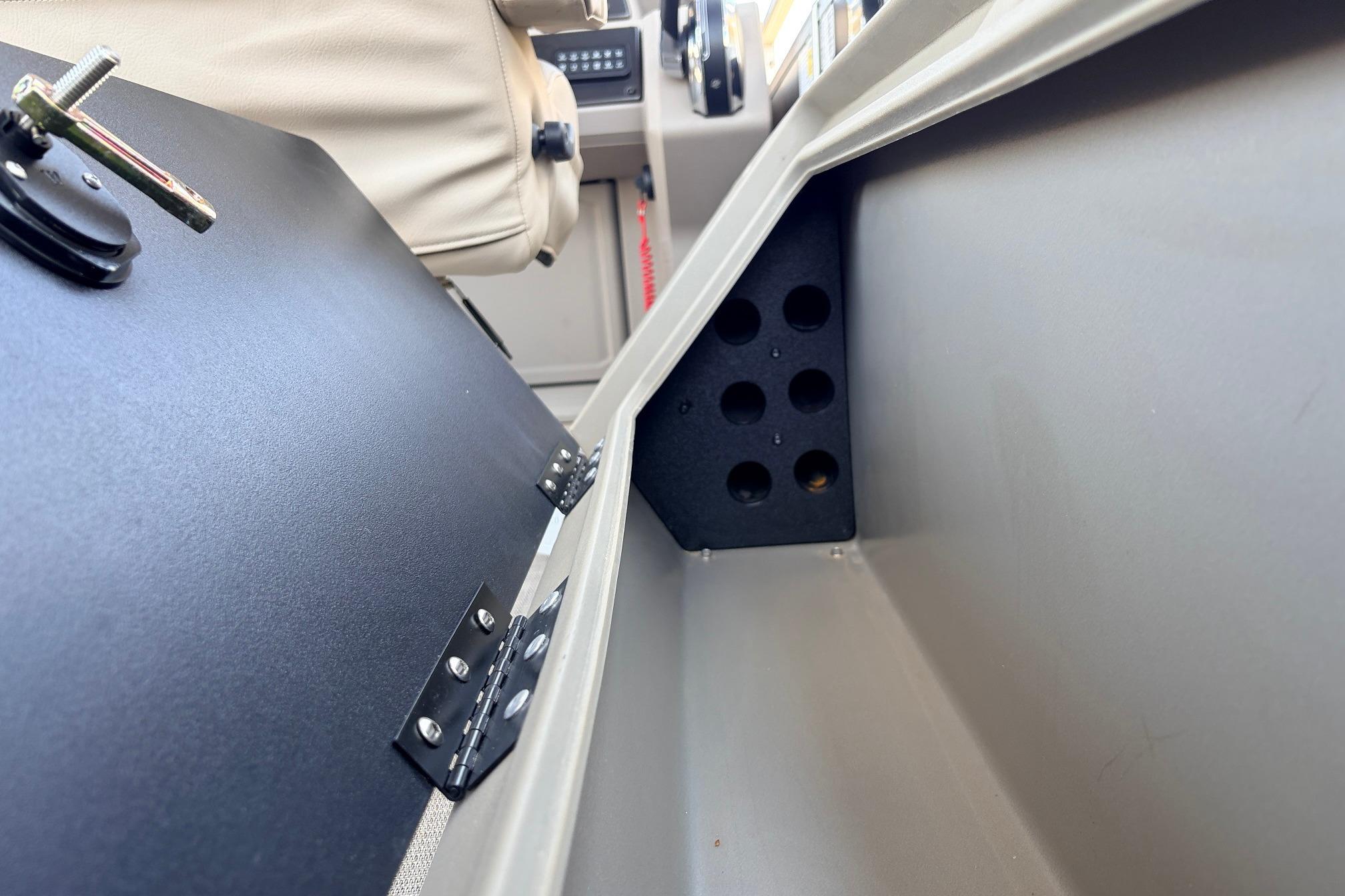 2024 Sun Tracker SportFish 22 XP3 interior storage compartment with hinged door and seating.