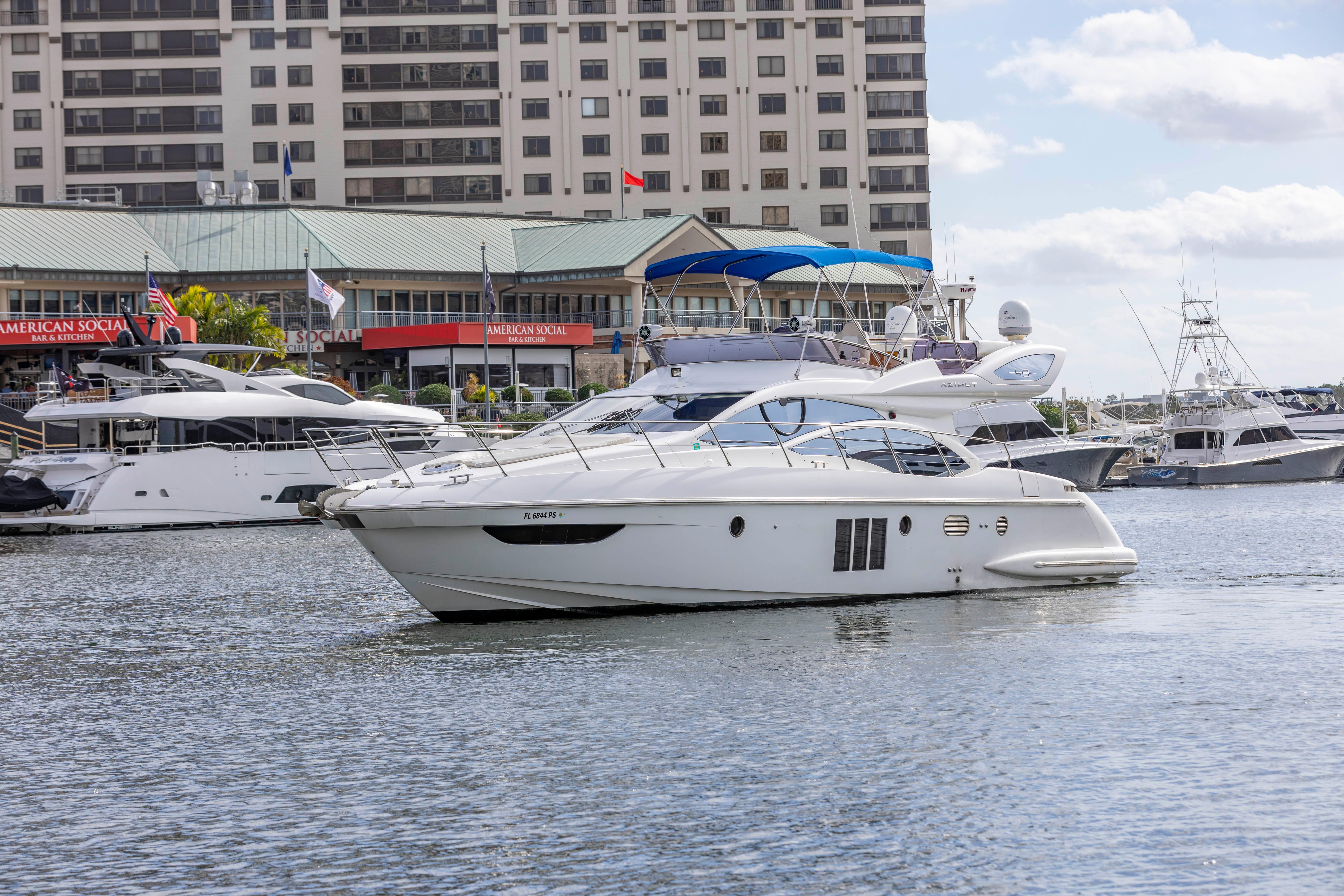 2012 Azimut 48 Flybridge yacht docked in a marina with other boats.