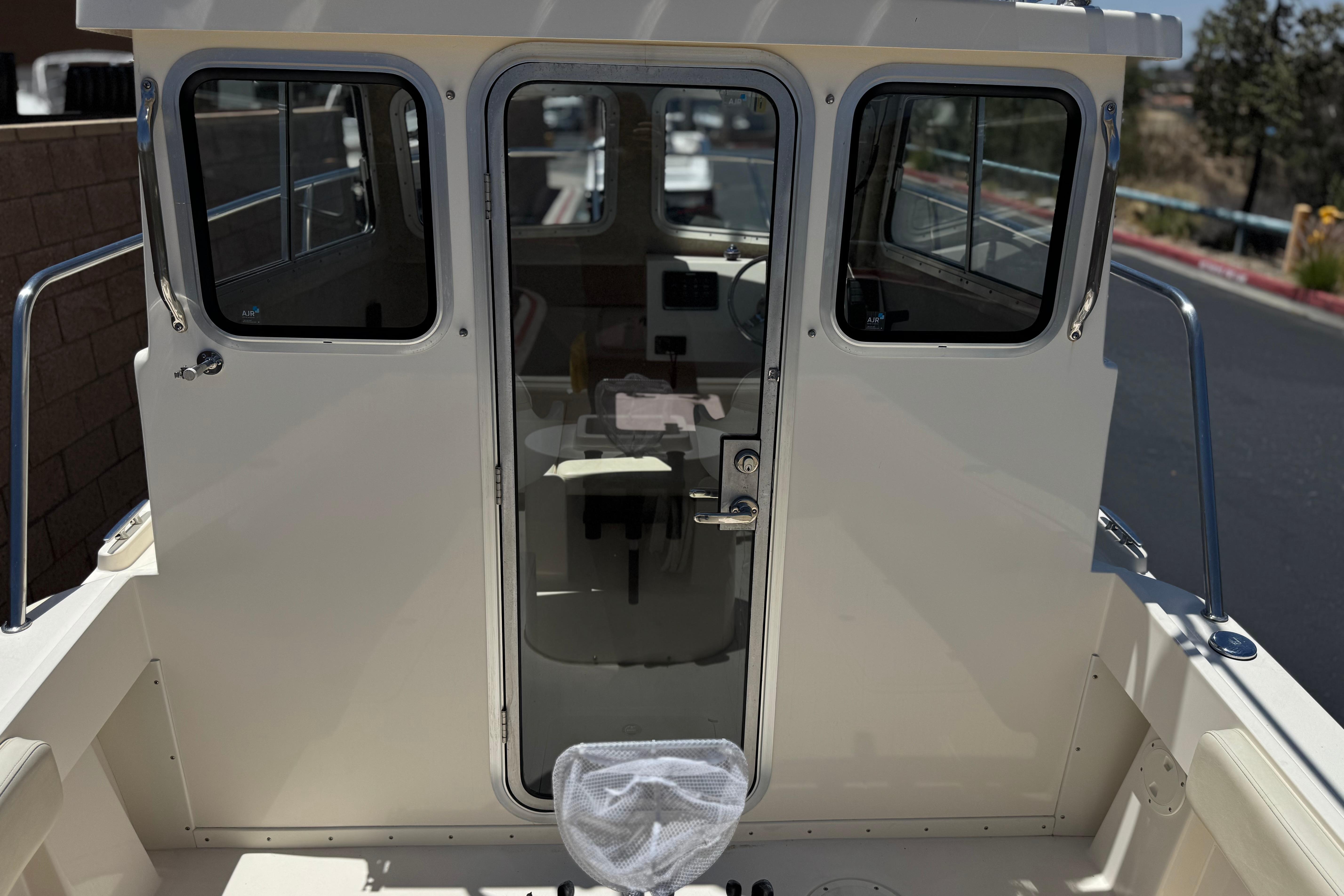 2017 Defiance Admiral 220 EX boat cabin entrance with glass door and side windows.