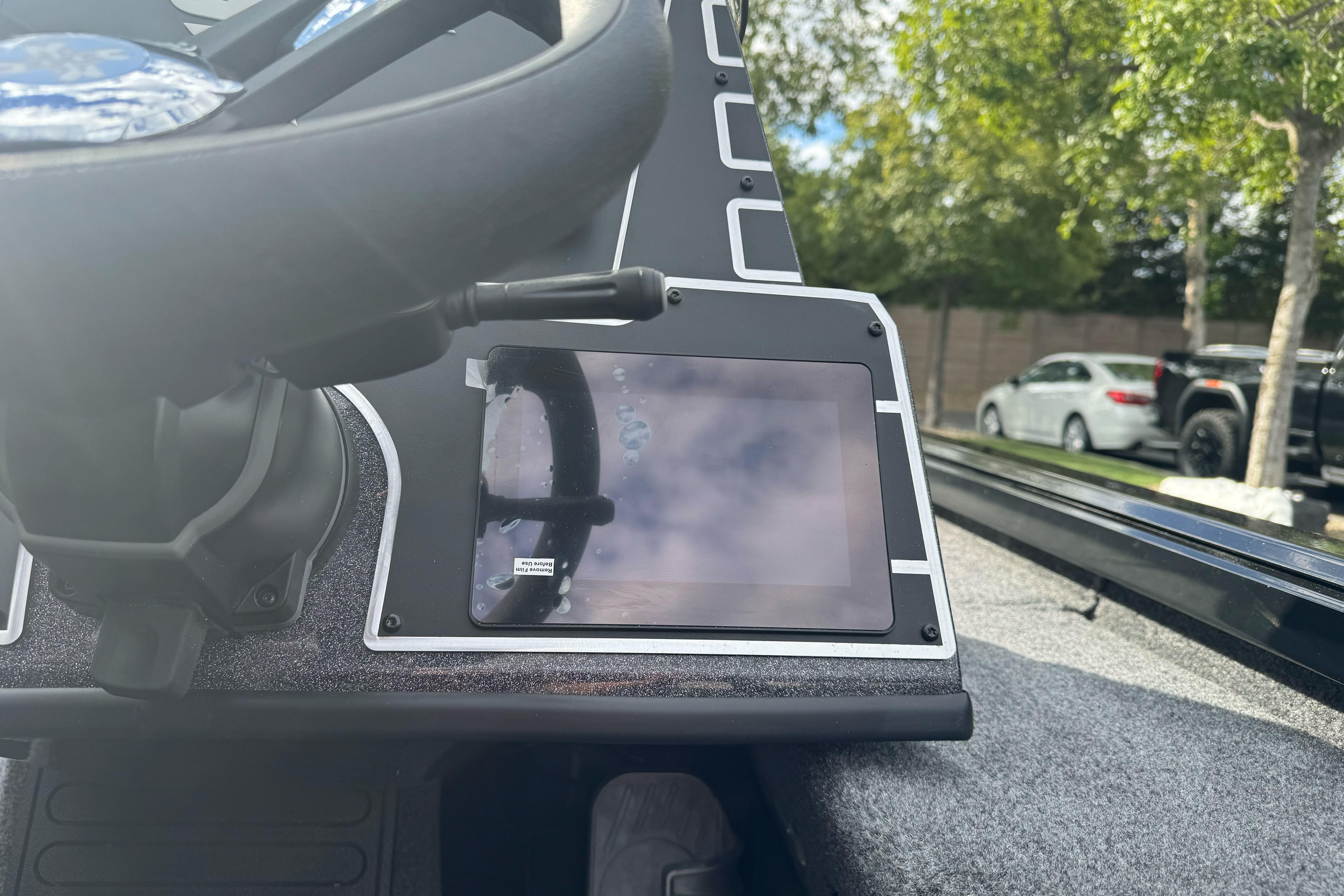 Steering wheel and dashboard of 2026 Ranger ALPHA 208 boat, featuring a digital display.