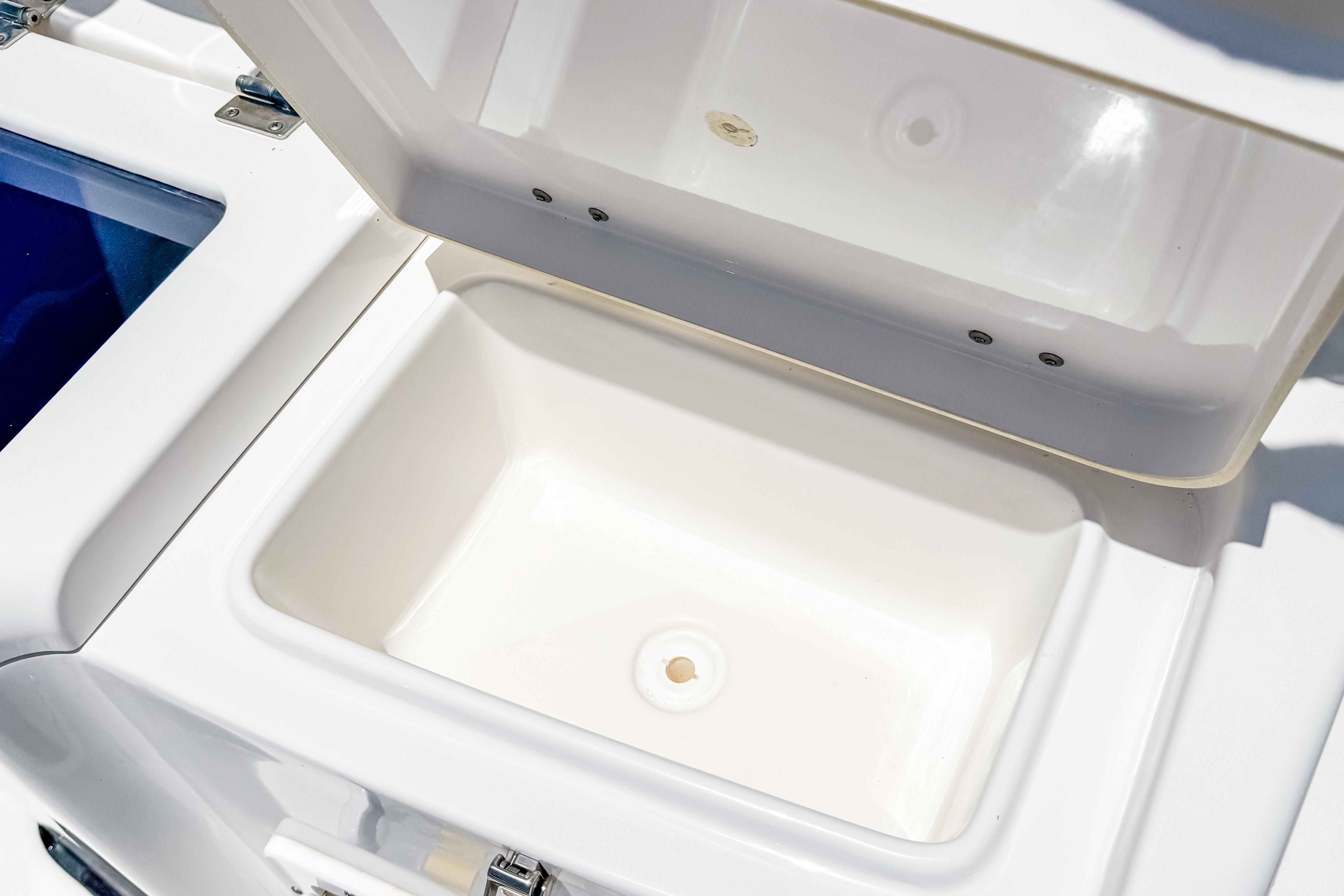 Open storage compartment on 2023 Tidewater 280 CC Adventure boat.