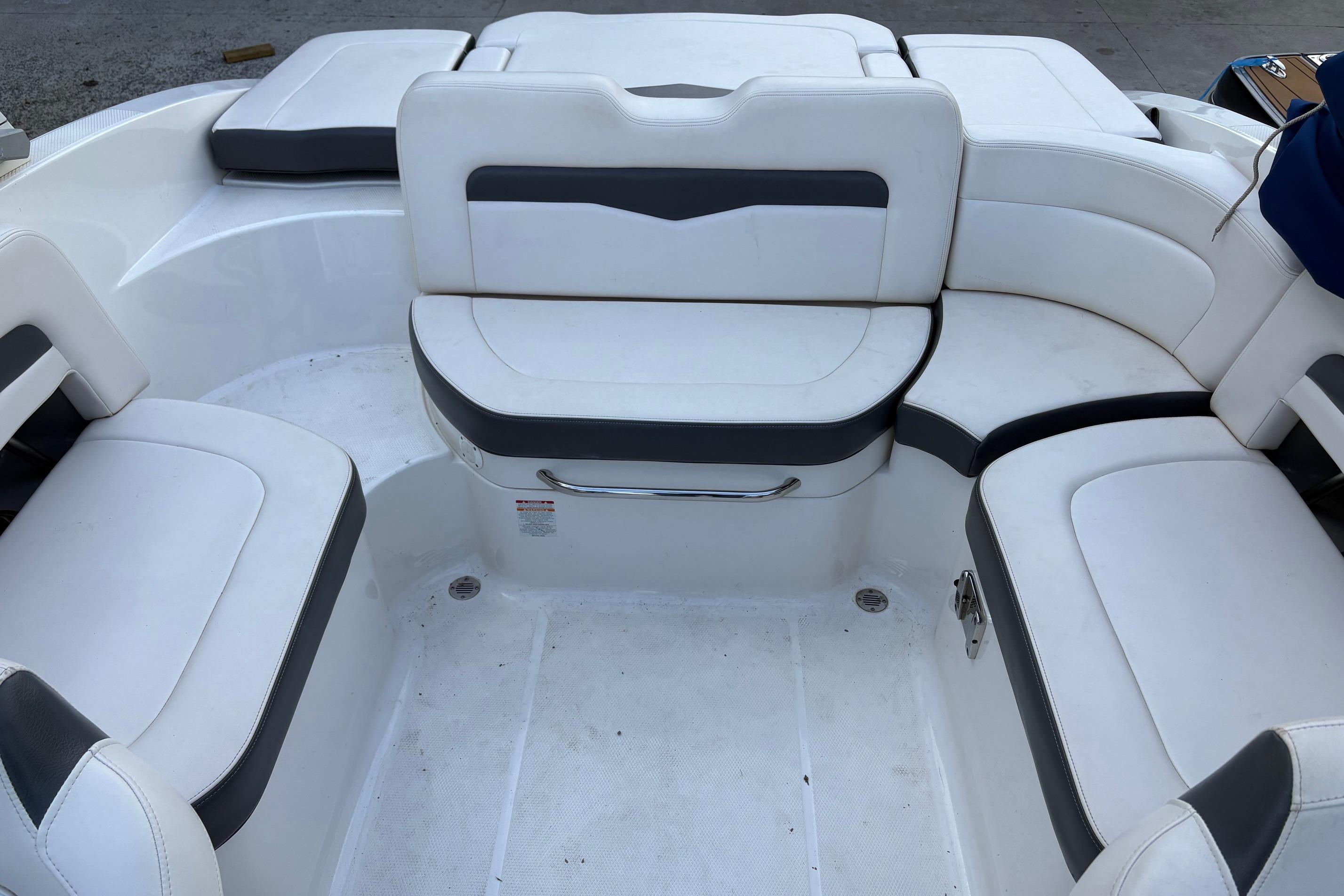 2016 Chaparral 246 SSi boat interior with white cushioned seating arrangement.