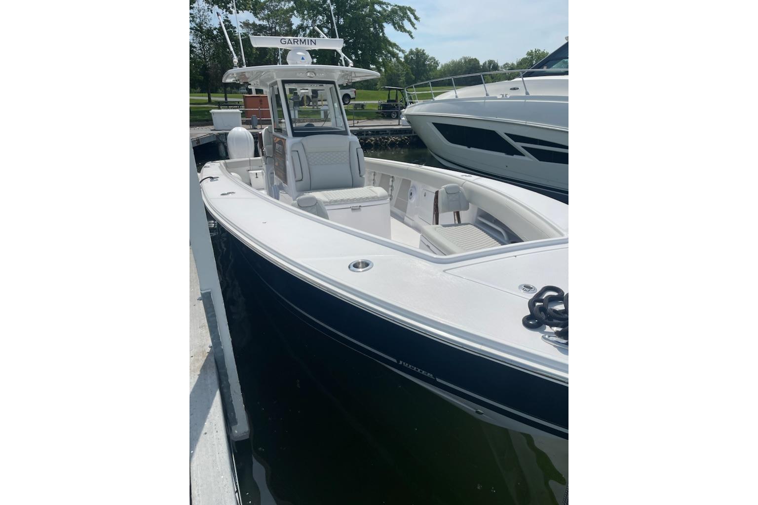 2026 Jupiter 340LS boat docked, featuring sleek design and Garmin equipment.