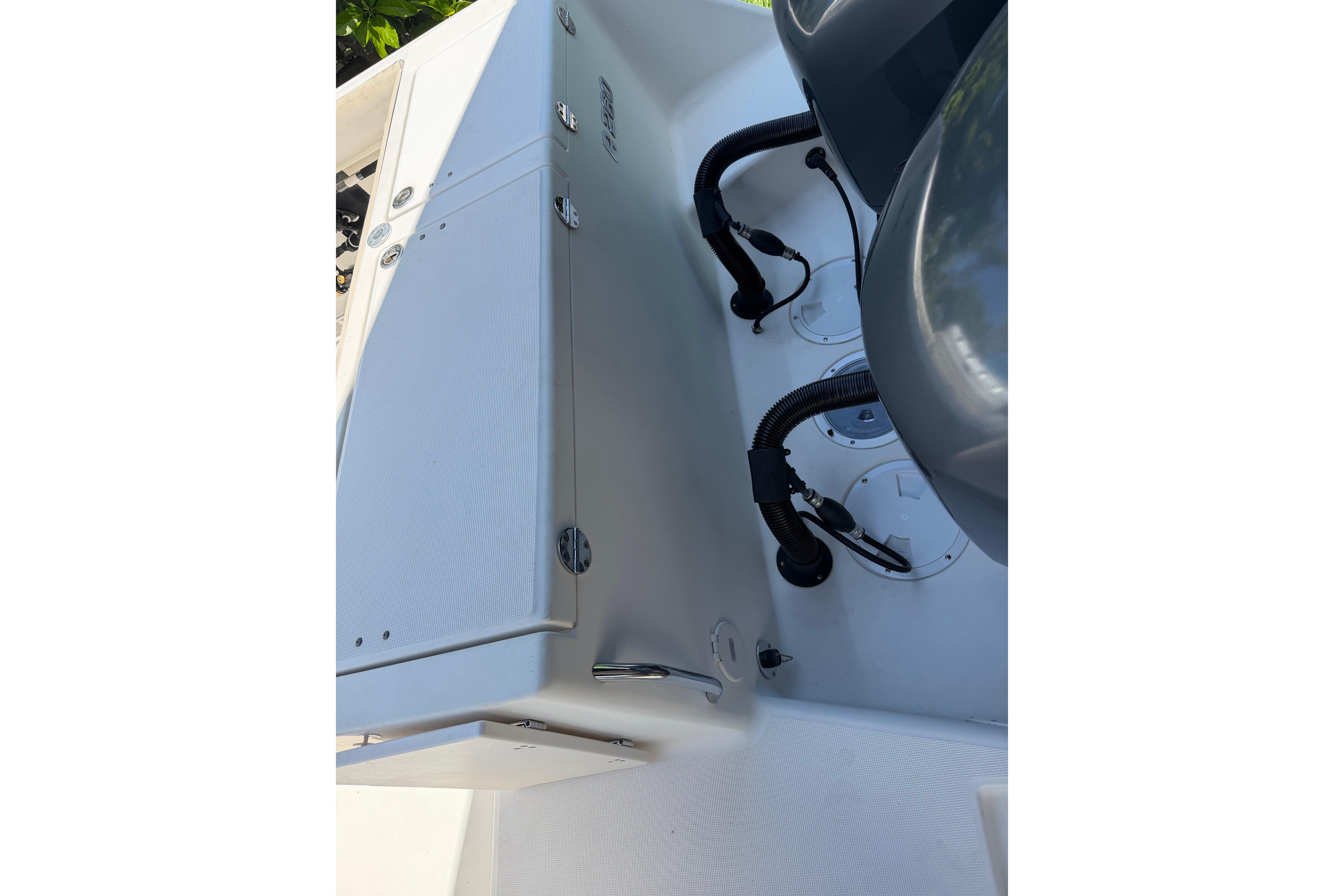 2007 Robalo R260 Center Console boat interior with storage compartments and engine cables.