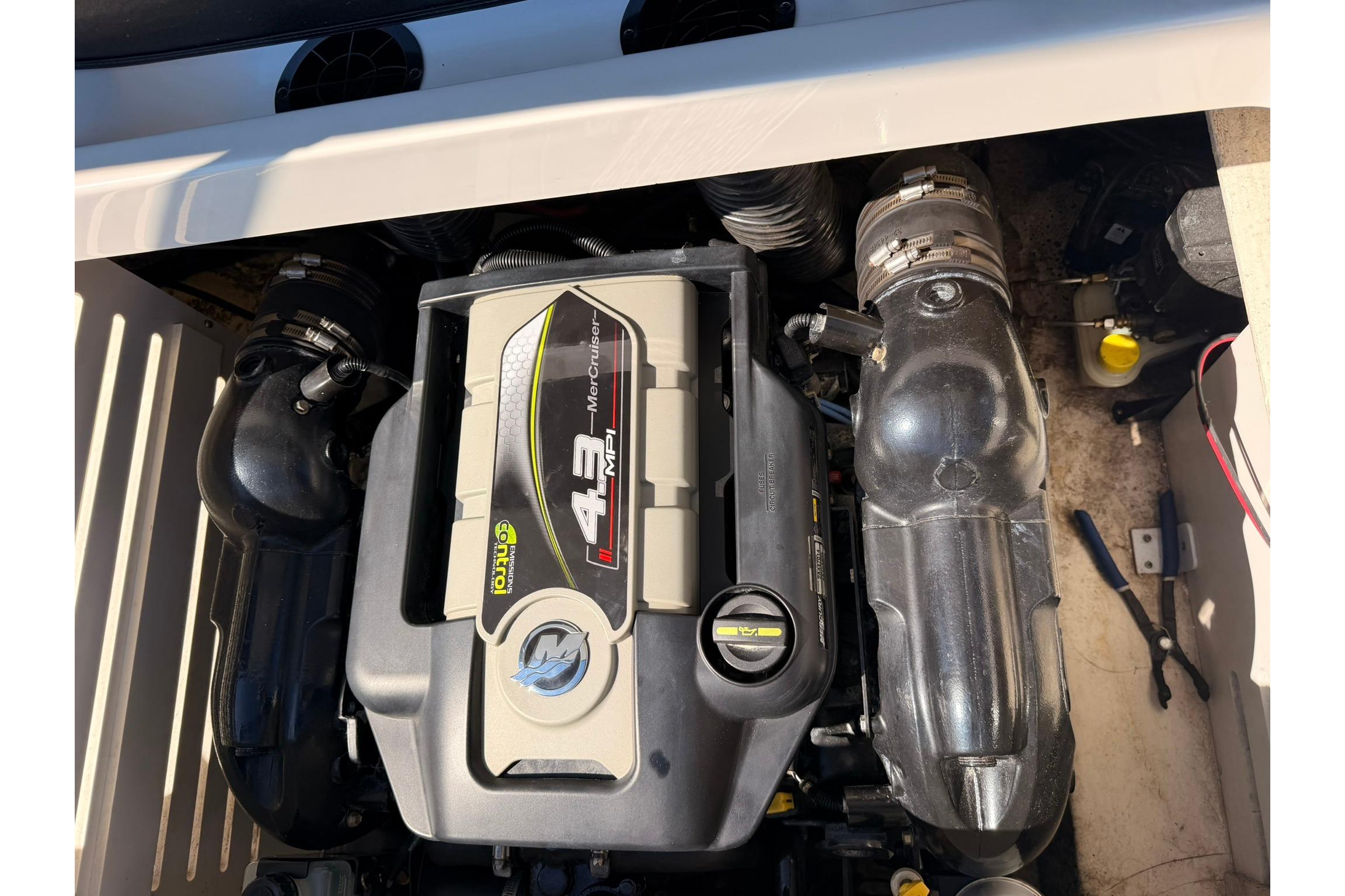 Engine compartment of a 2016 Sea Ray SPX 210 boat, featuring a 4.3L MerCruiser engine.