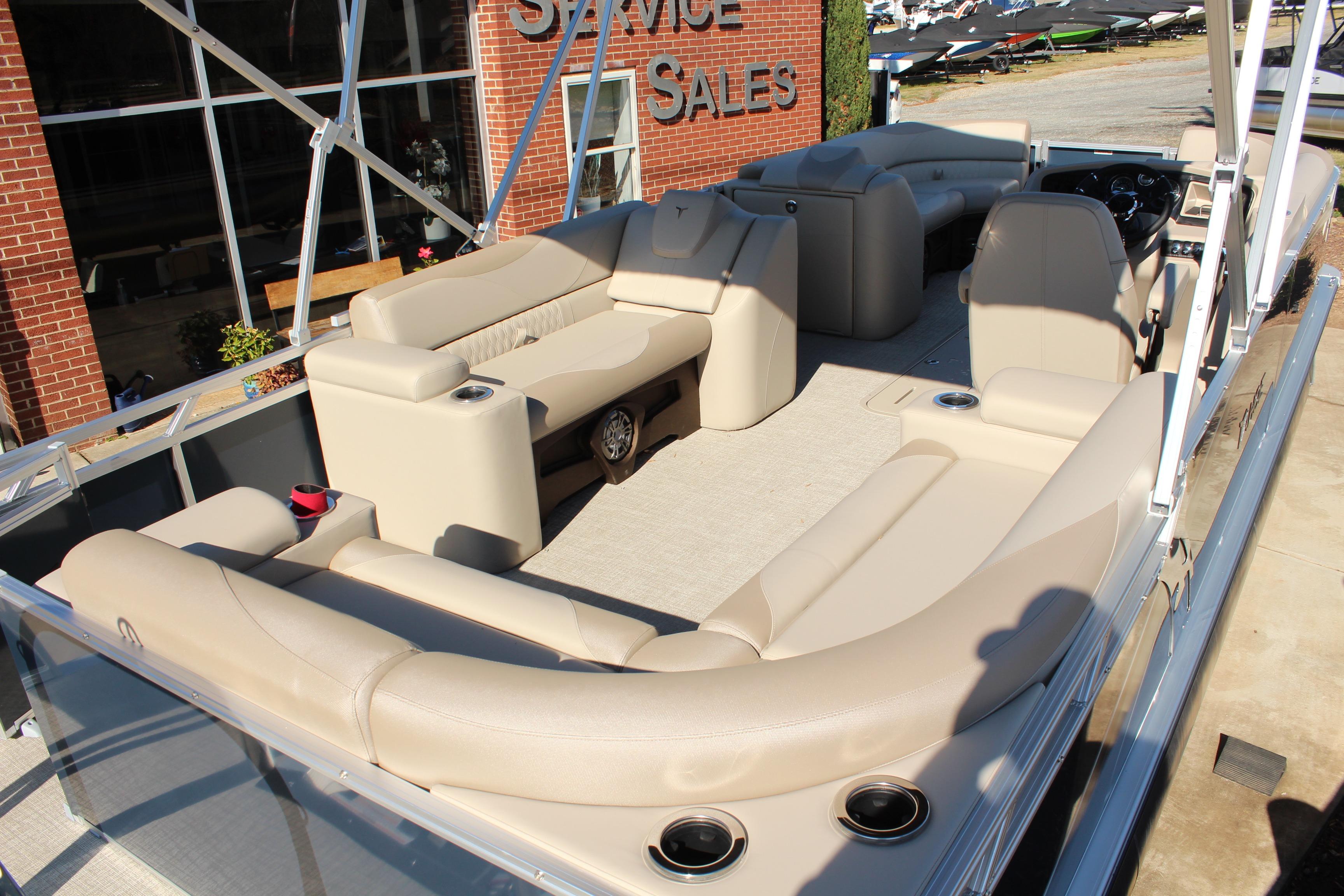 2026 Tahoe Pontoon LTZ Elite with luxurious seating and modern design at a sales location.