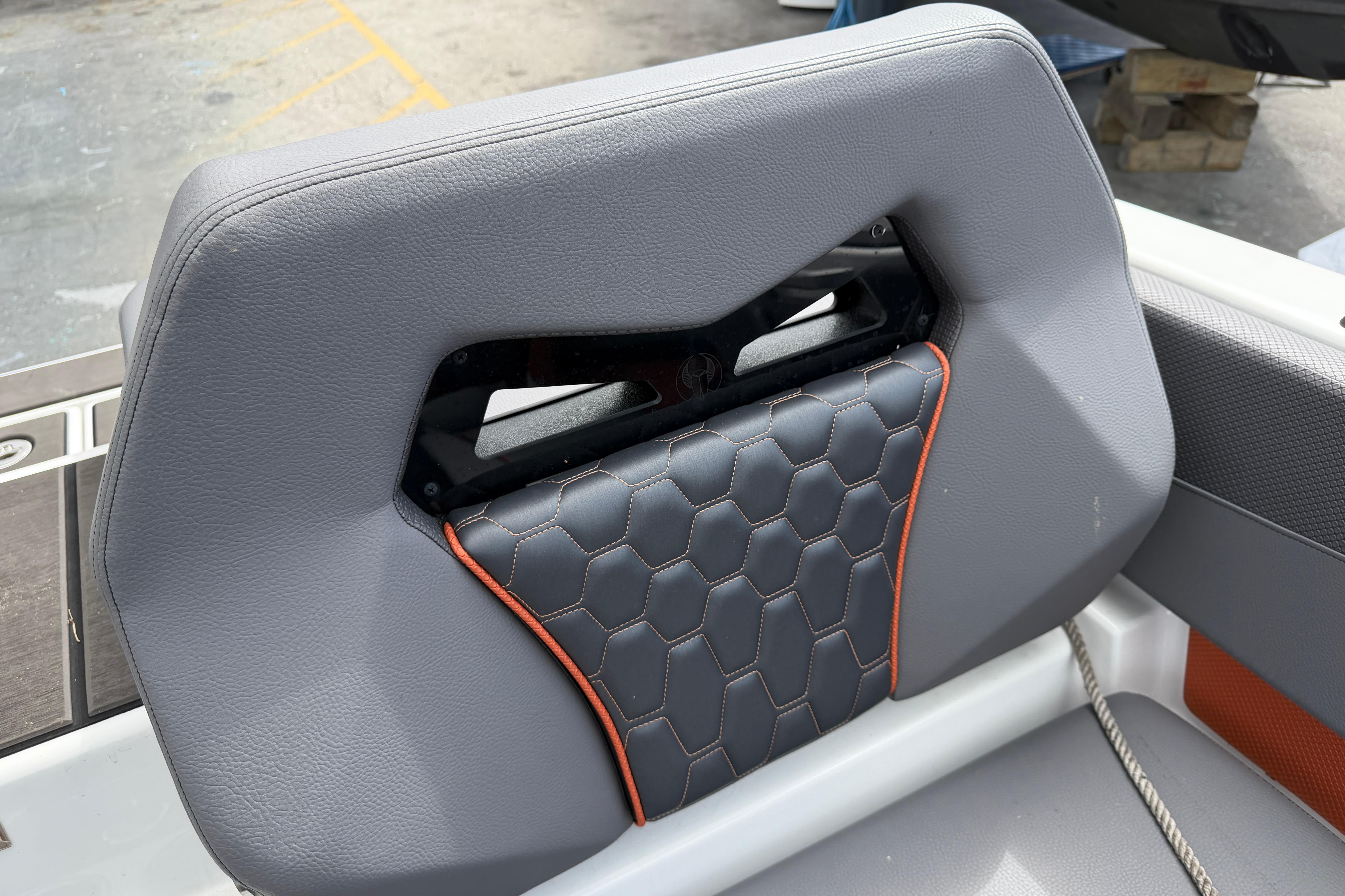 2026 Scarab 235 LX boat seat with hexagonal stitching and orange accents.