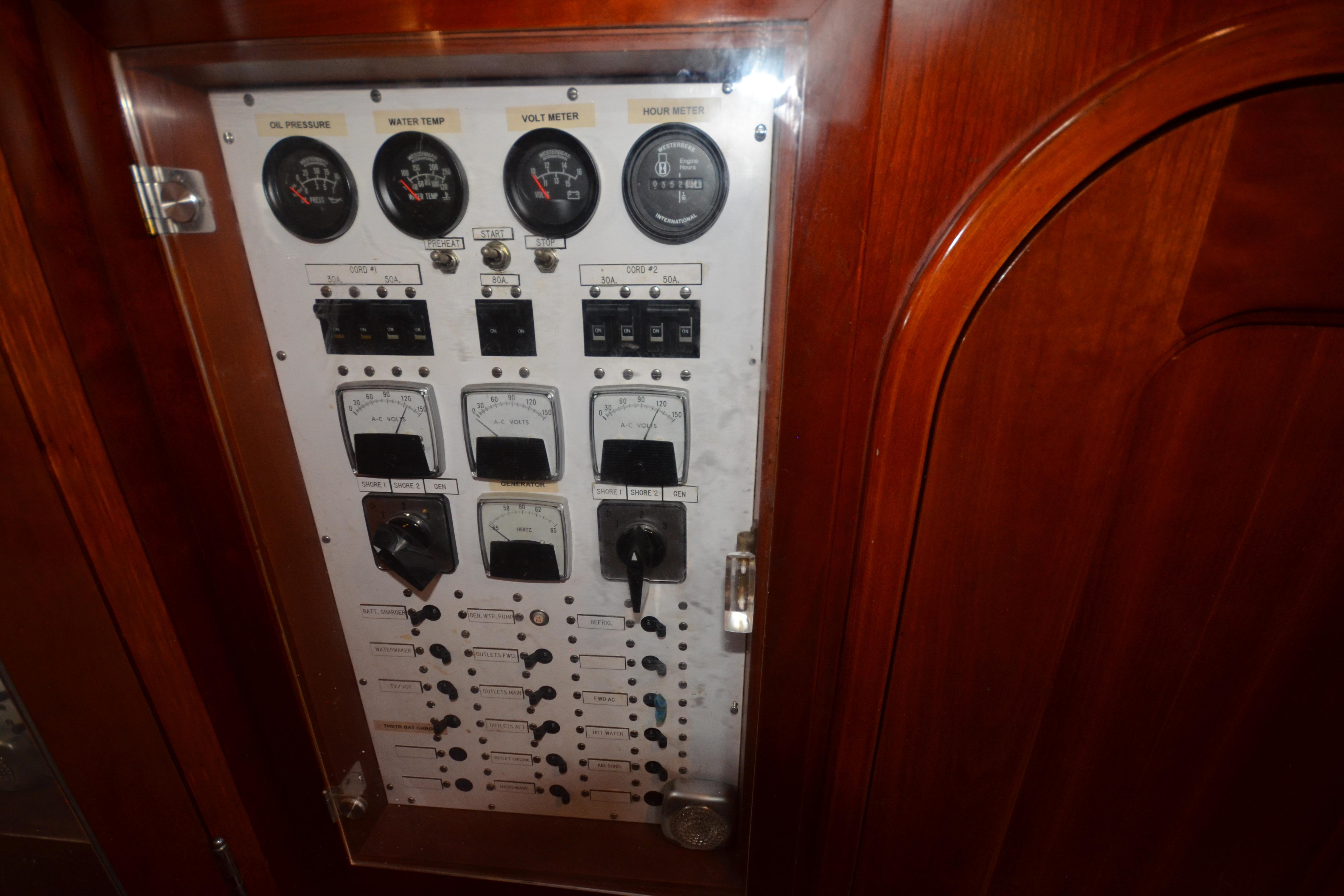 Control panel of a 1992 Hinckley Sou'wester 59 yacht with gauges and switches.