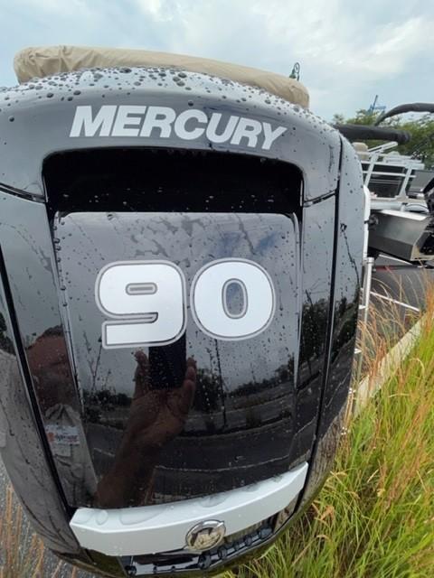 Mercury 90 horsepower engine on 2024 Sun Tracker SportFish 20 DLX boat, wet with raindrops.