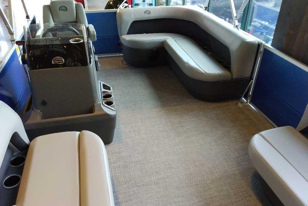 Interior of 2026 Sun Tracker Party Barge 16 DLX with seating and helm.