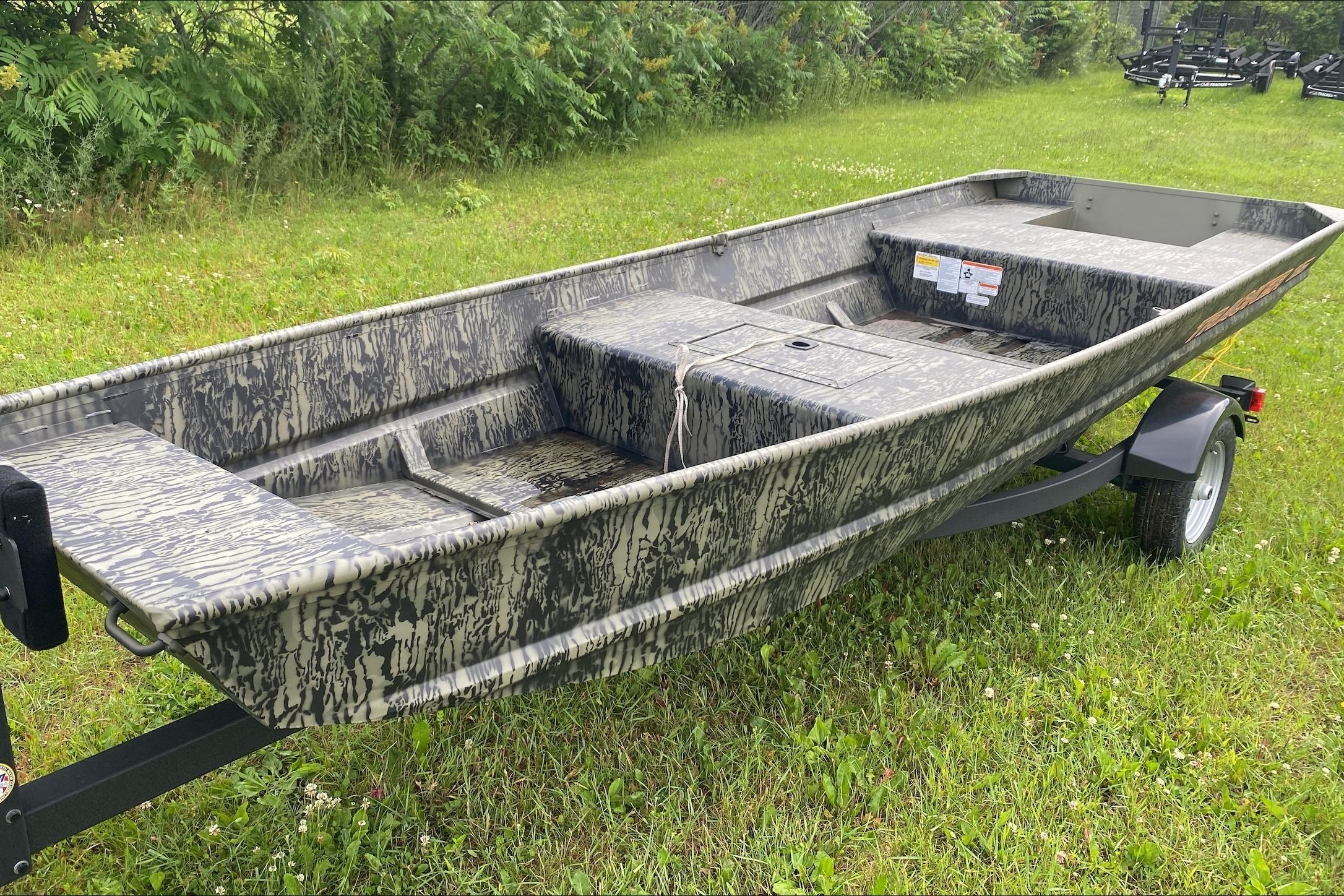 2026 Tracker Grizzly 15 Jon boat on grassy field, showcasing camouflage design.
