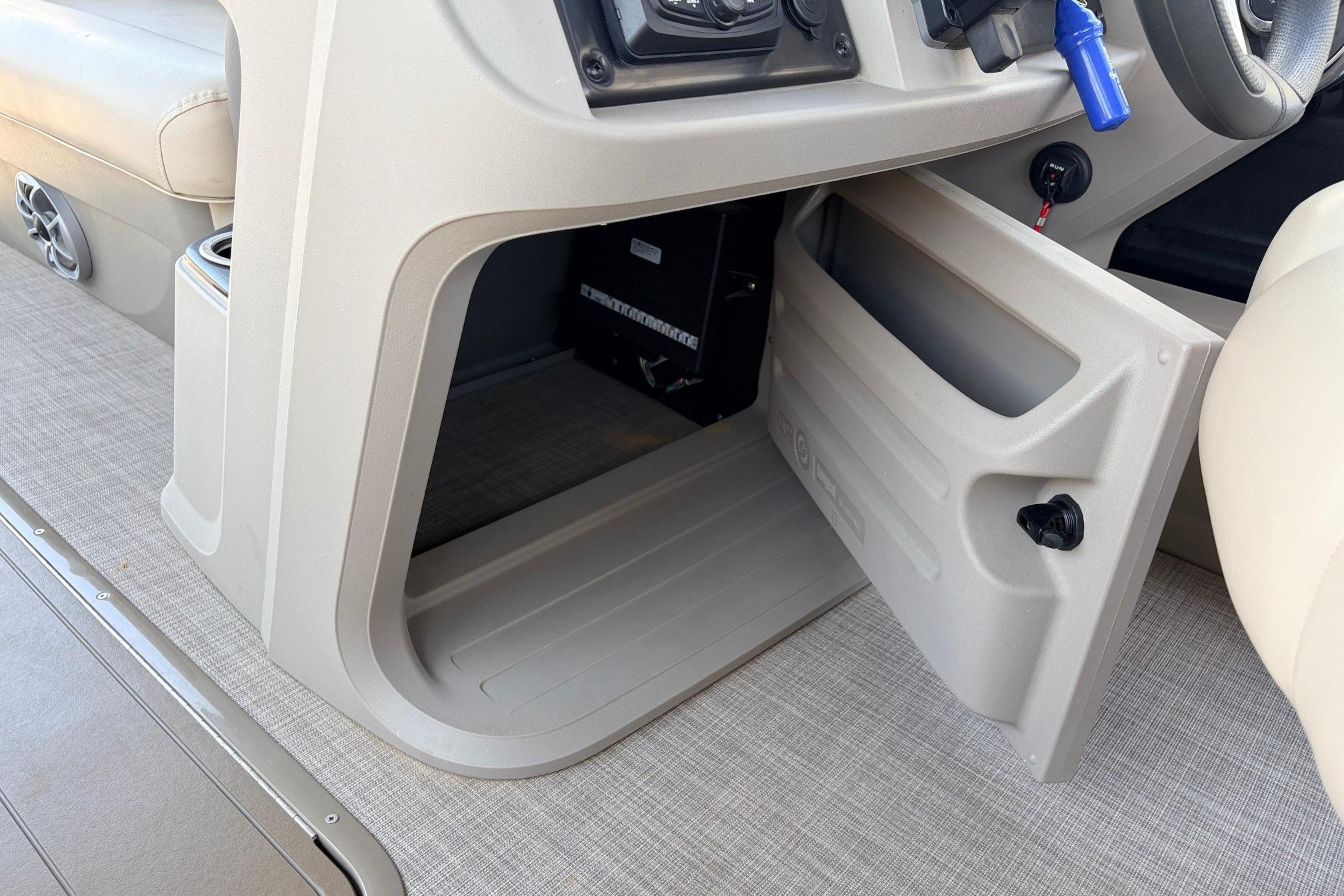 2024 Sun Tracker SportFish 22 XP3 storage compartment with open door, showcasing interior space.