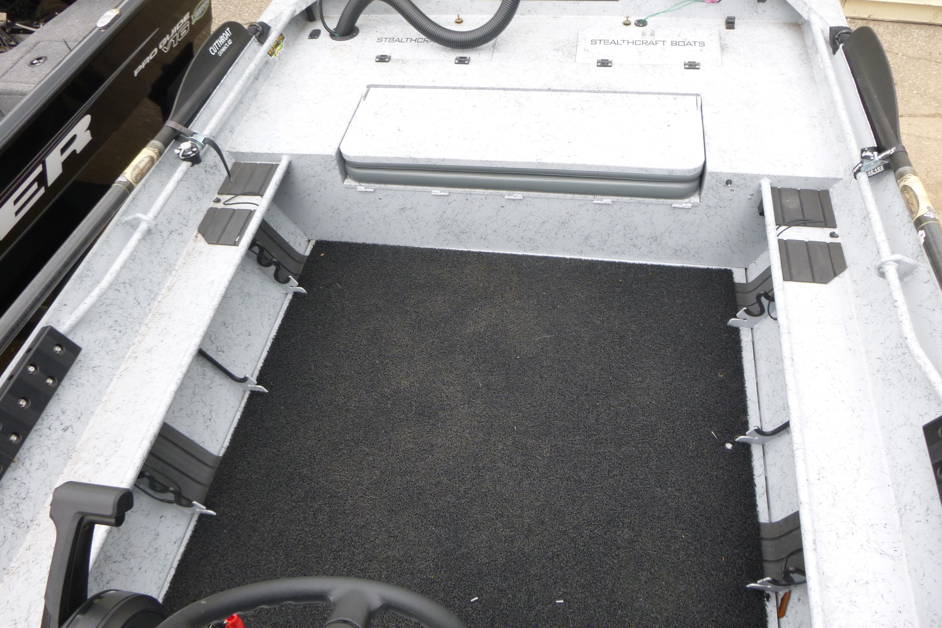 2025 StealthCraft 16 StealthWeld boat interior with rod holders and carpeted floor.