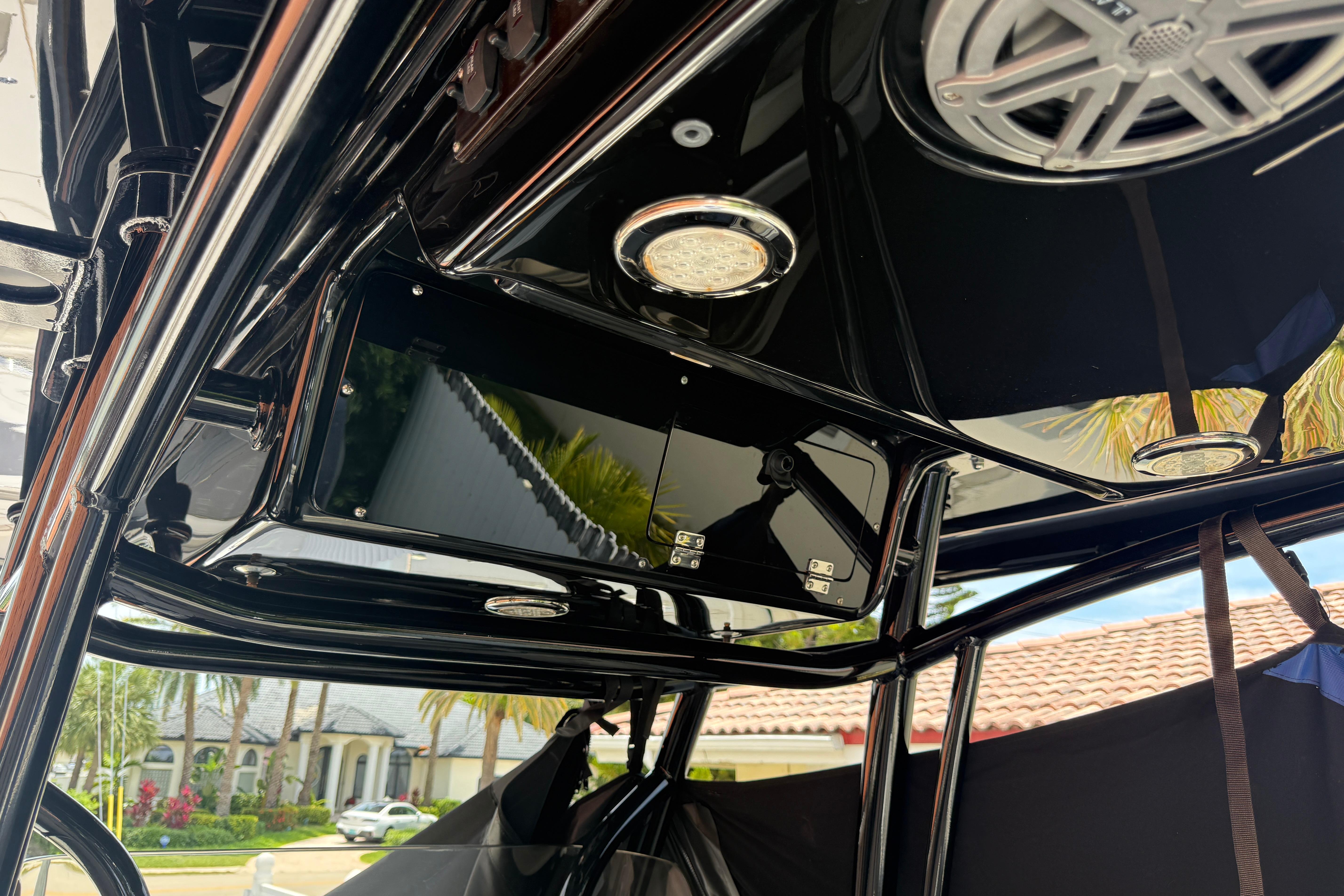 Interior view of a 2015 Blackwood 27 boat with sleek black finish and speaker system.