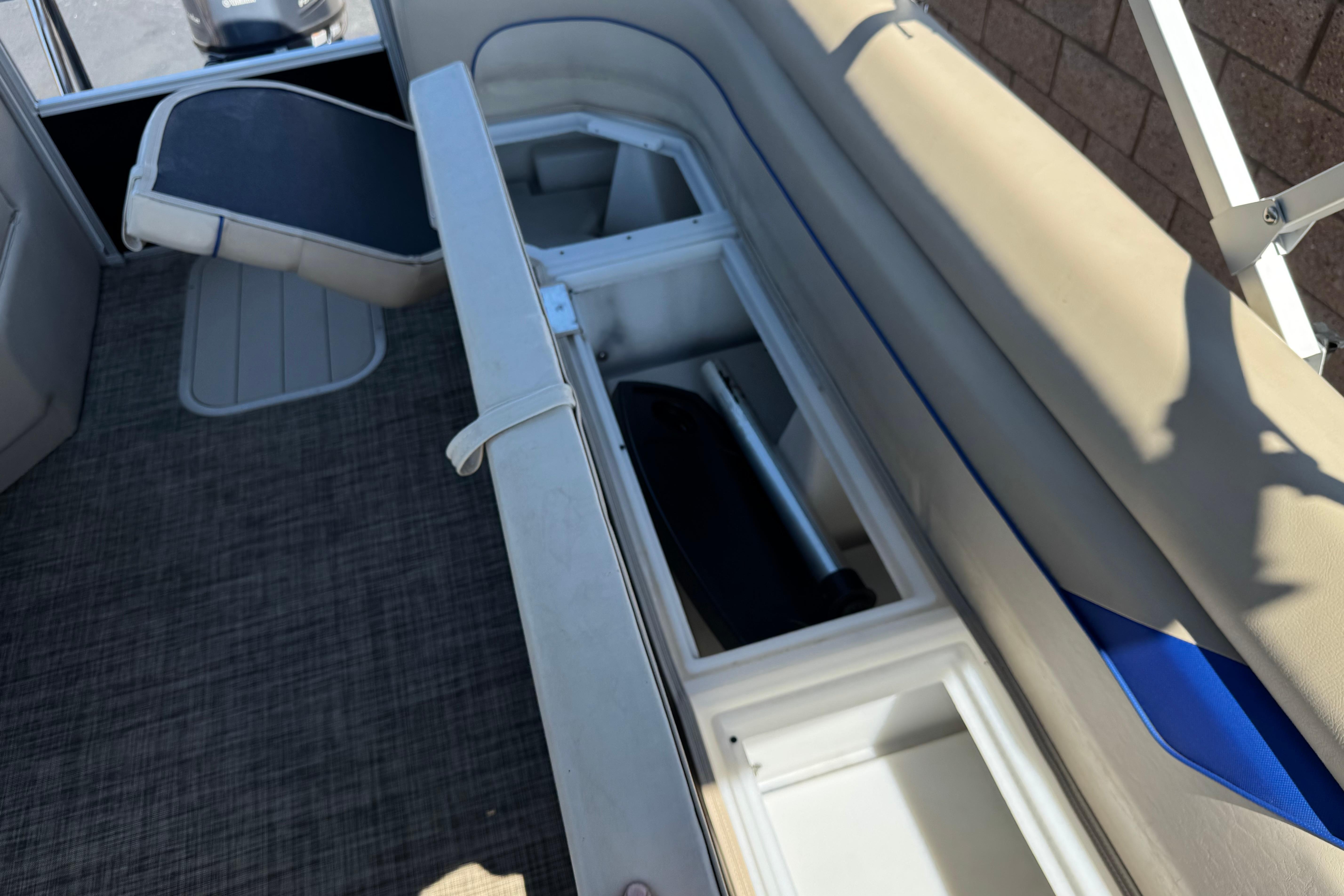 2021 SunCatcher Select 20RCX boat interior storage compartments with open seating.
