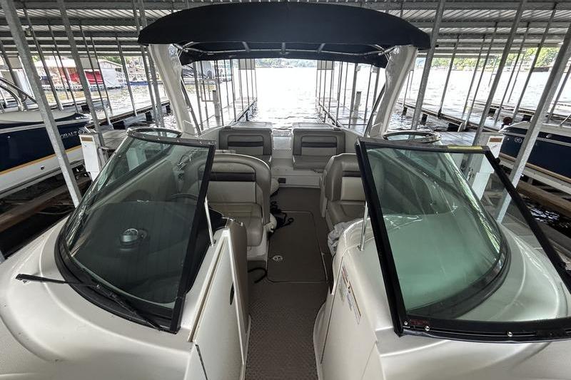 2011 Sea Ray 300 SLX boat interior with seating, docked under a covered marina.
