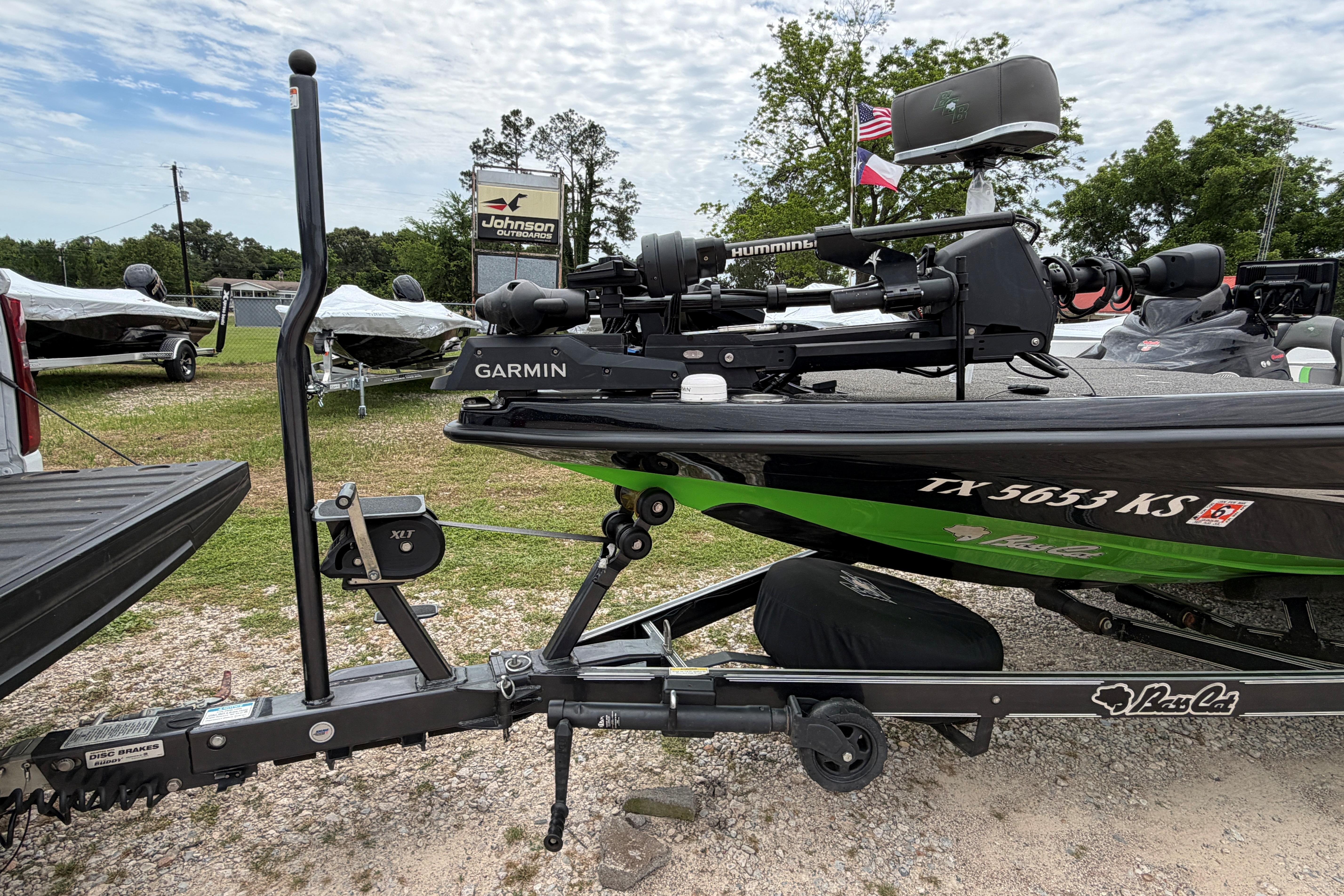 2023 BassCat Erya boat with Garmin equipment, parked outdoors near dealership.