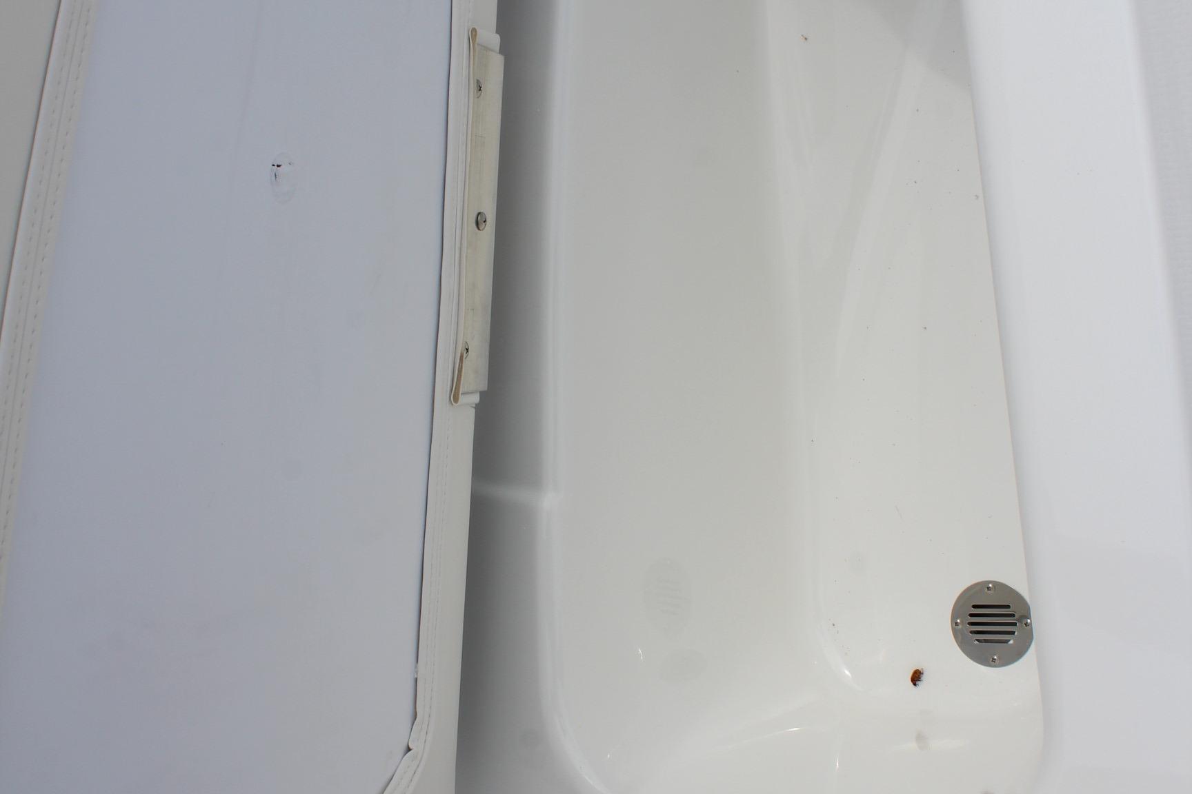 White interior compartment of 2026 Tahoe T16 boat with drain detail.