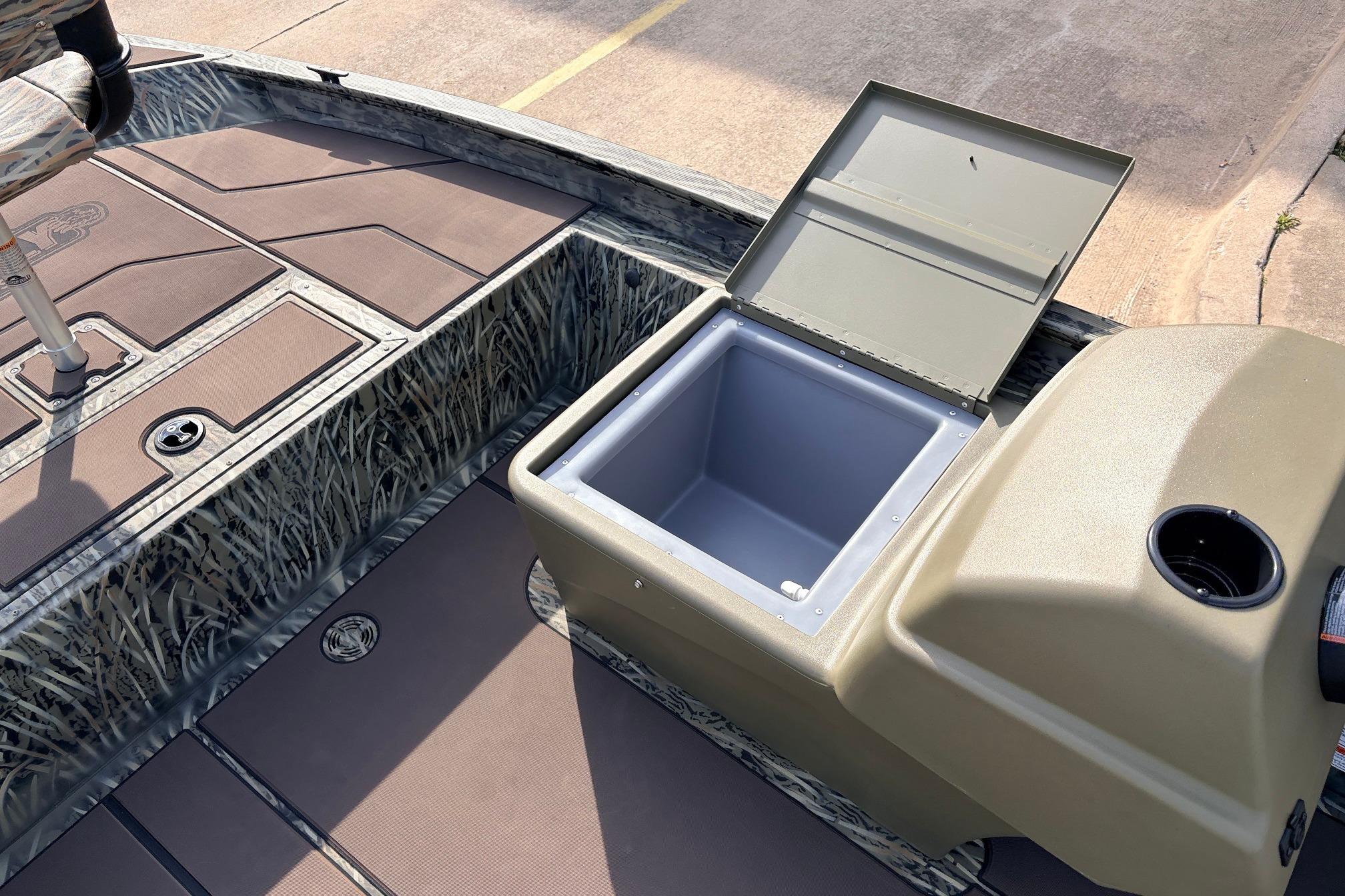 2026 Tracker Grizzly 1754 SC boat interior with open storage compartment and camouflage design.