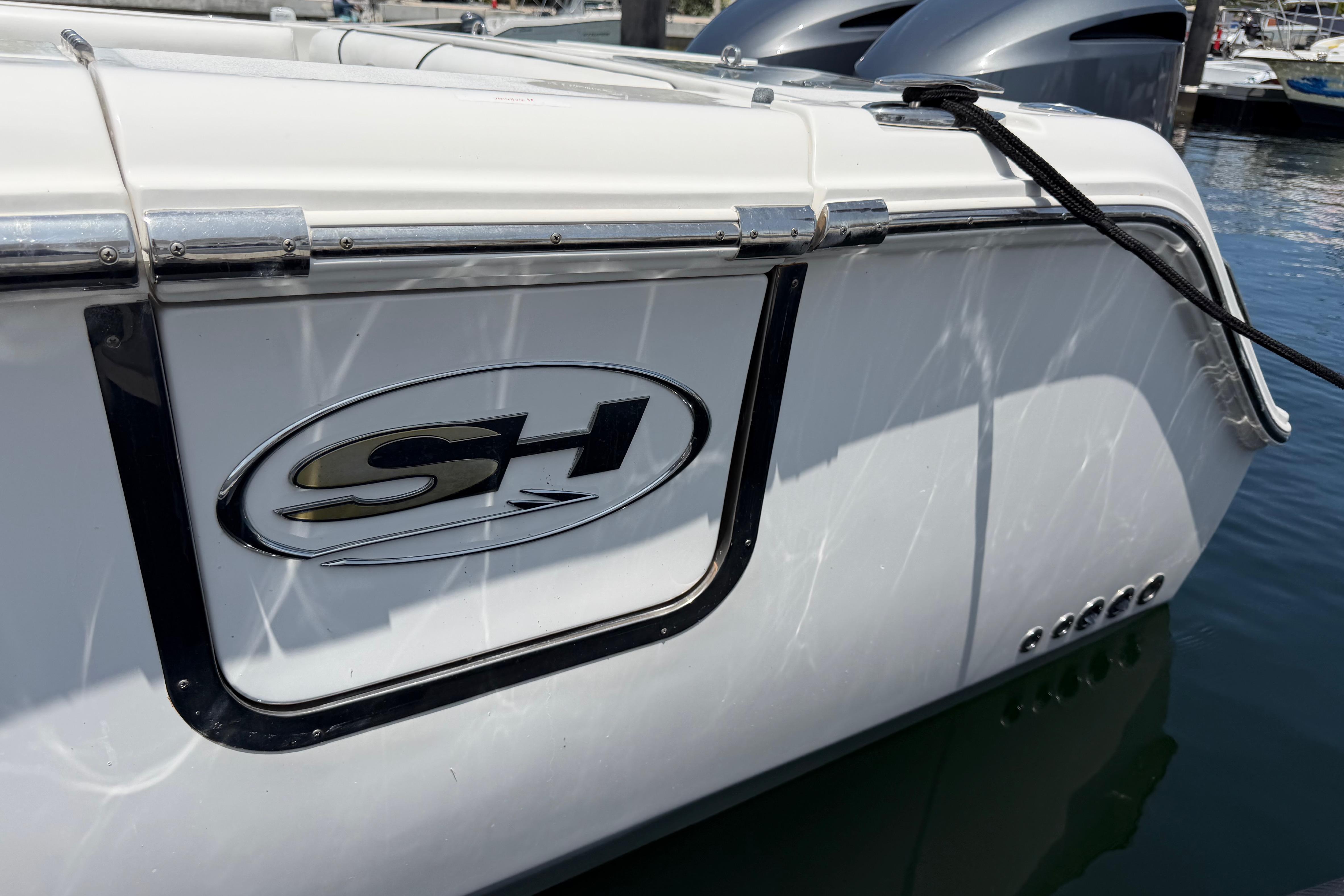 2019 Sea Hunt Gamefish 27 Coffin Box boat docked, featuring SH logo and sleek design.