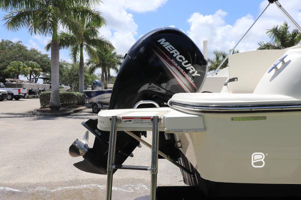 2018 Bayliner 210 DB boat with Mercury outboard motor in sunny marina setting.