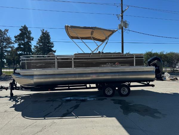2025 Sun Tracker 24 Sportfish XP3 pontoon boat with canopy on trailer.