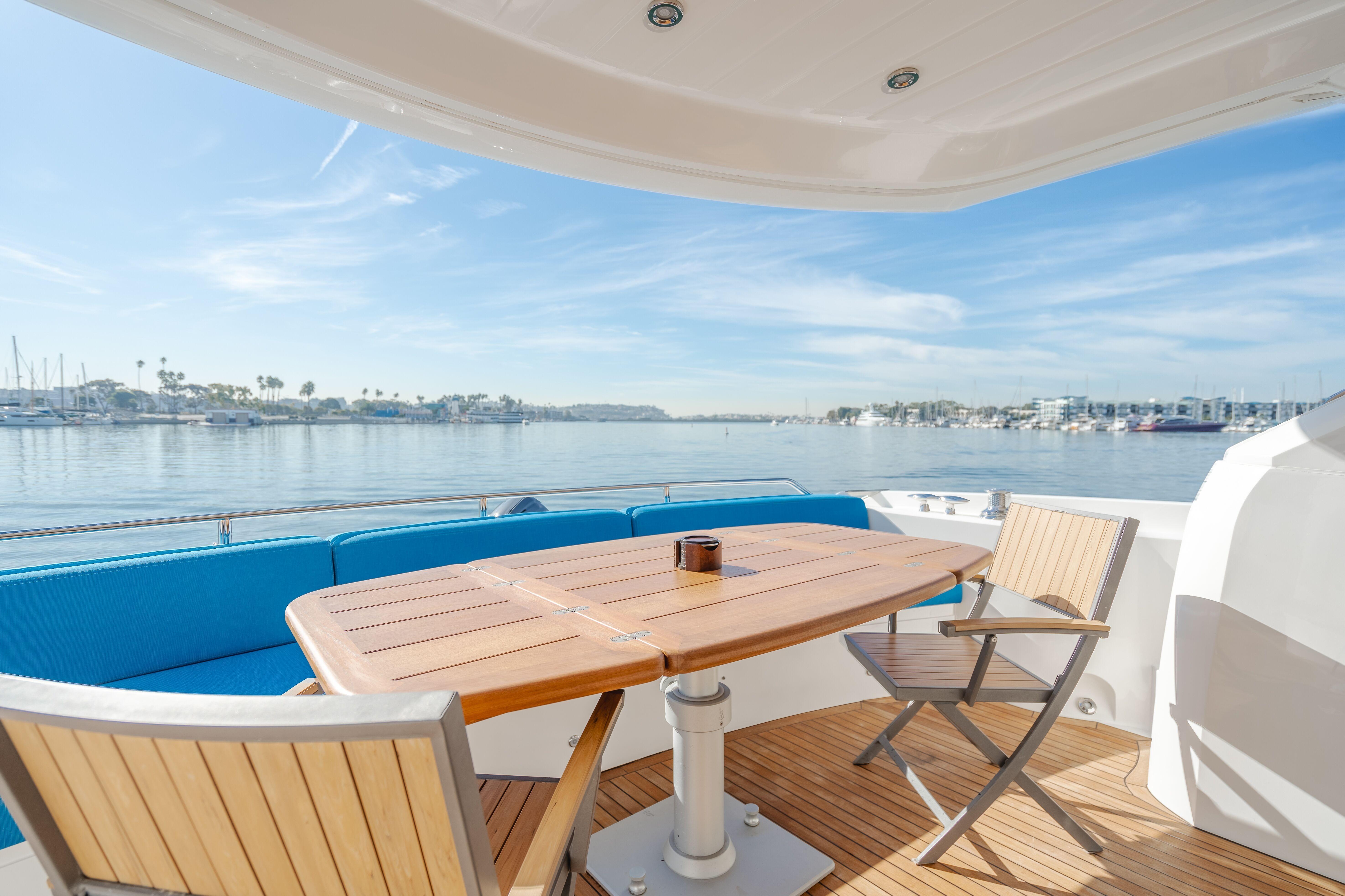 Luxurious Sunseeker Manhattan 60 yacht deck with seating, overlooking serene waters, 2010 model.