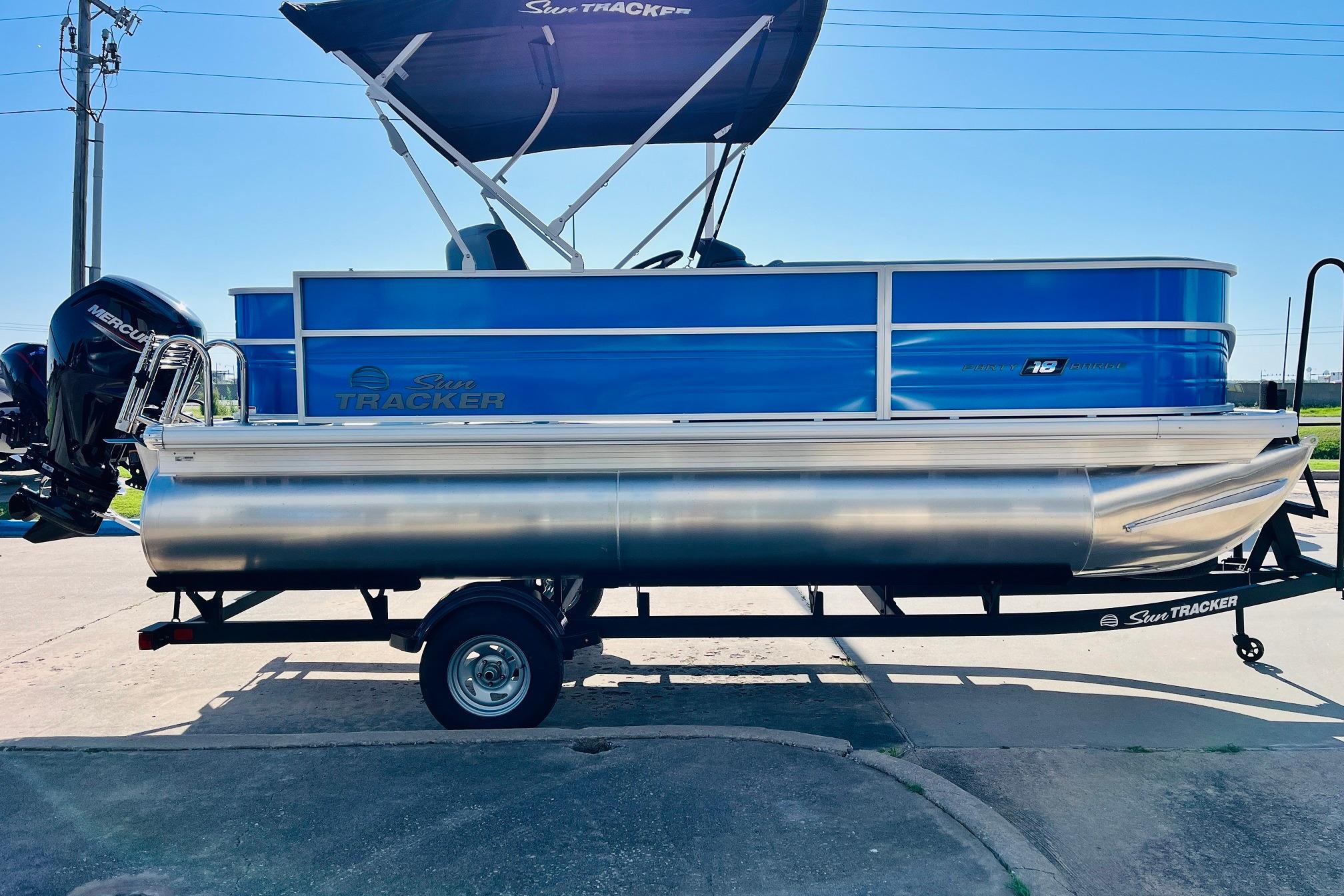 2026 Sun Tracker Party Barge 18 DLX pontoon boat on trailer, side view.