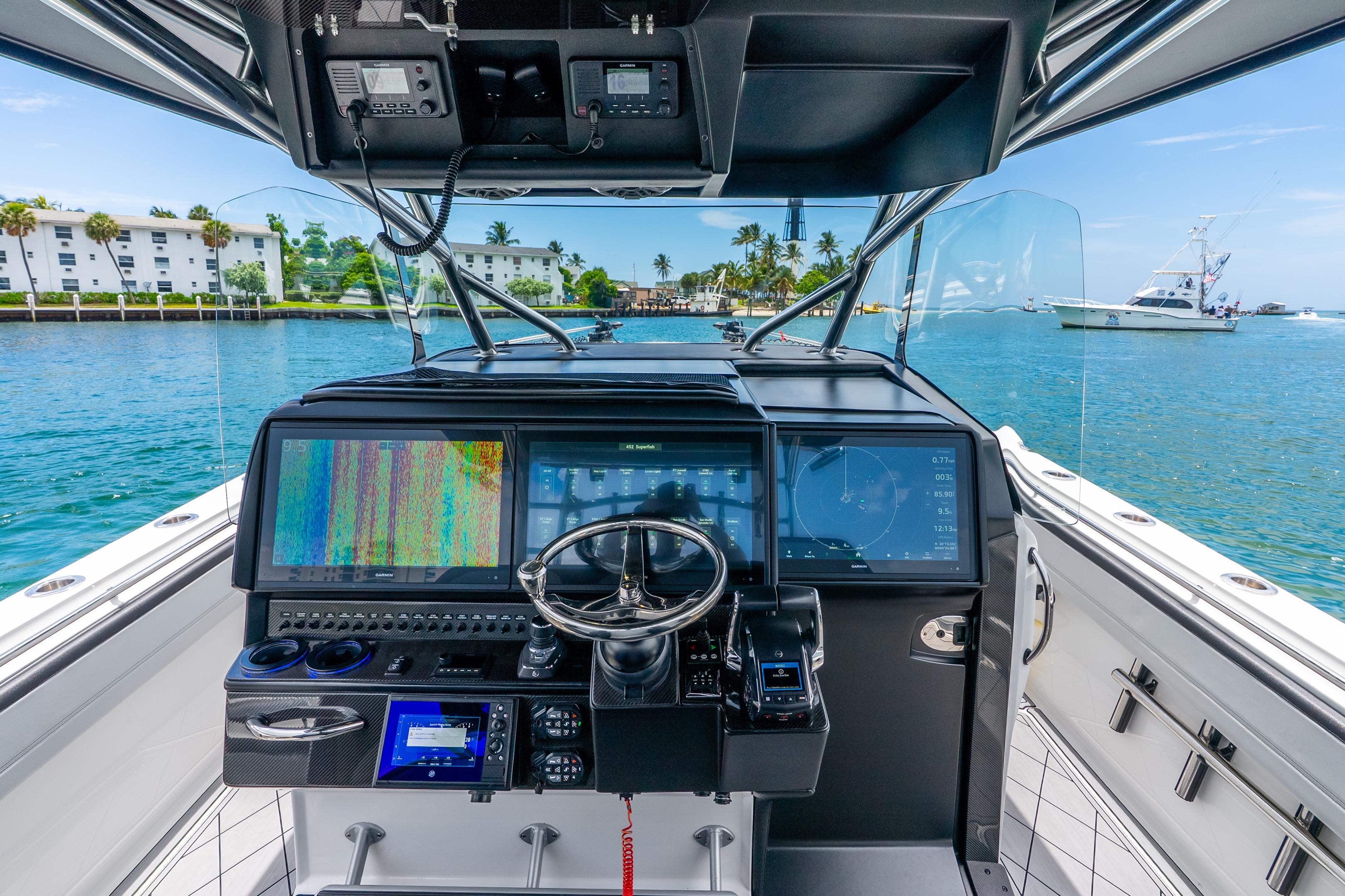 2024 Nor-Tech 452 Super Fish boat cockpit with advanced navigation systems on a sunny day.