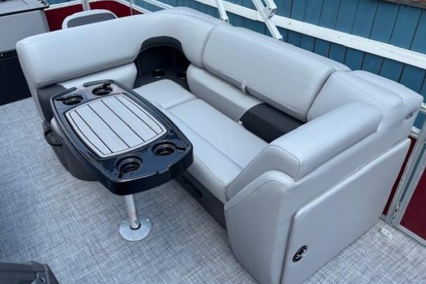2026 Sun Tracker SportFish 20 DLX boat interior with gray seating and table.