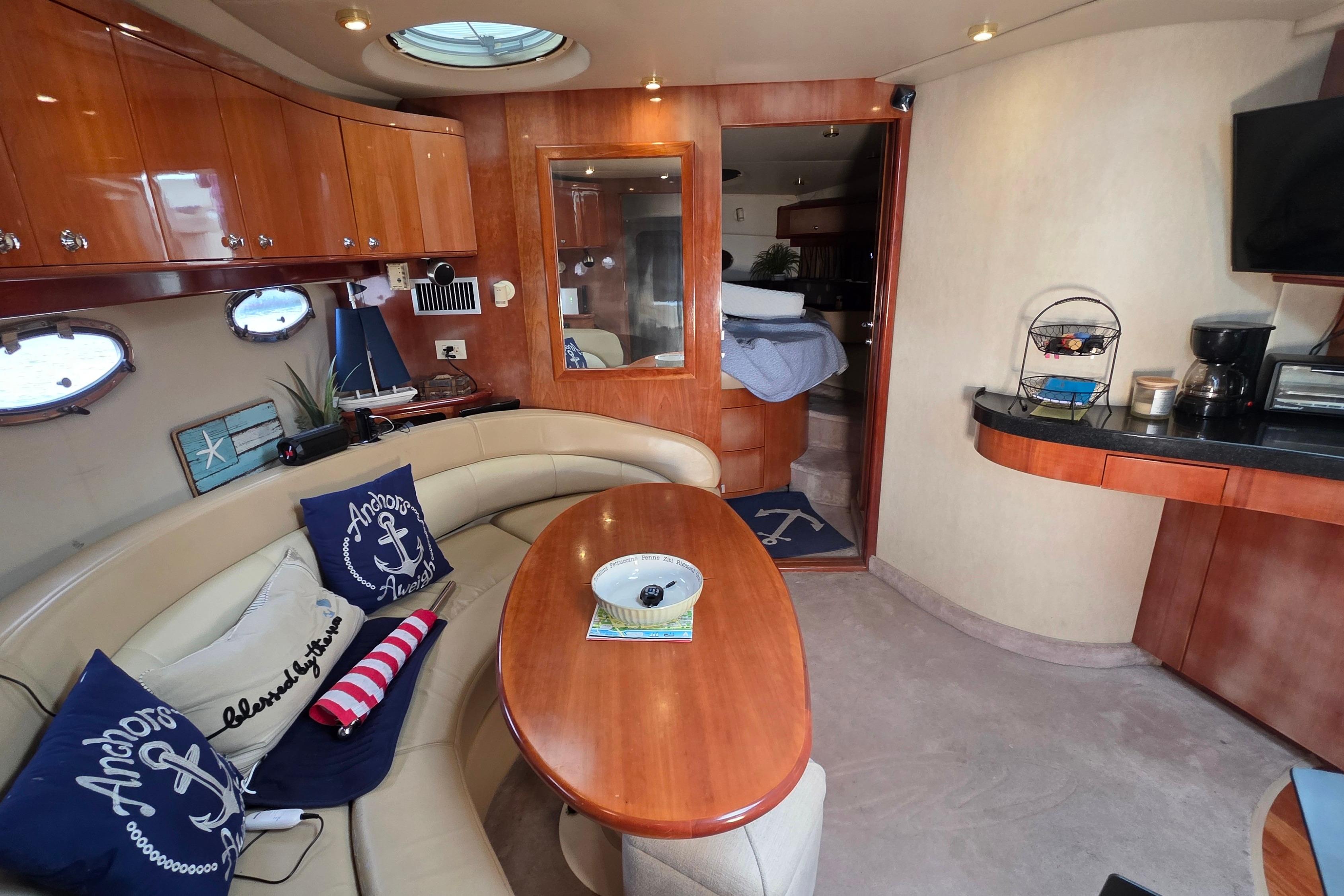Luxurious 2002 Regal Commodore 4260 yacht interior with elegant seating and nautical decor.
