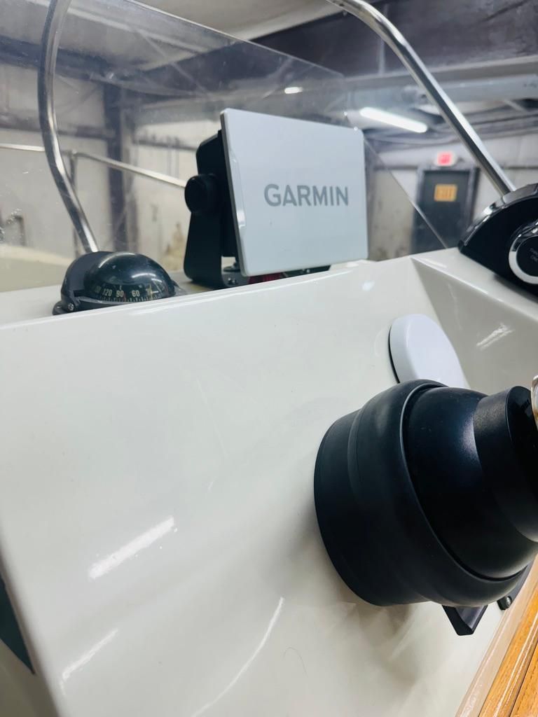 The image shows the cockpit of a 1986 Boston Whaler 17 Montauk with a Garmin device.