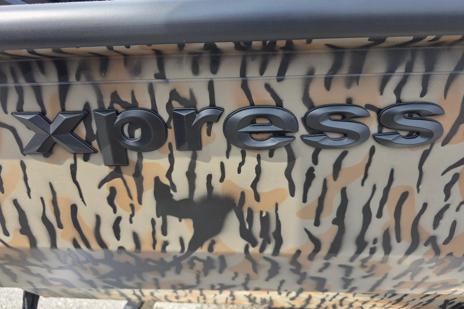 2026 Xpress H22B Bay boat with camouflage pattern and bold logo.