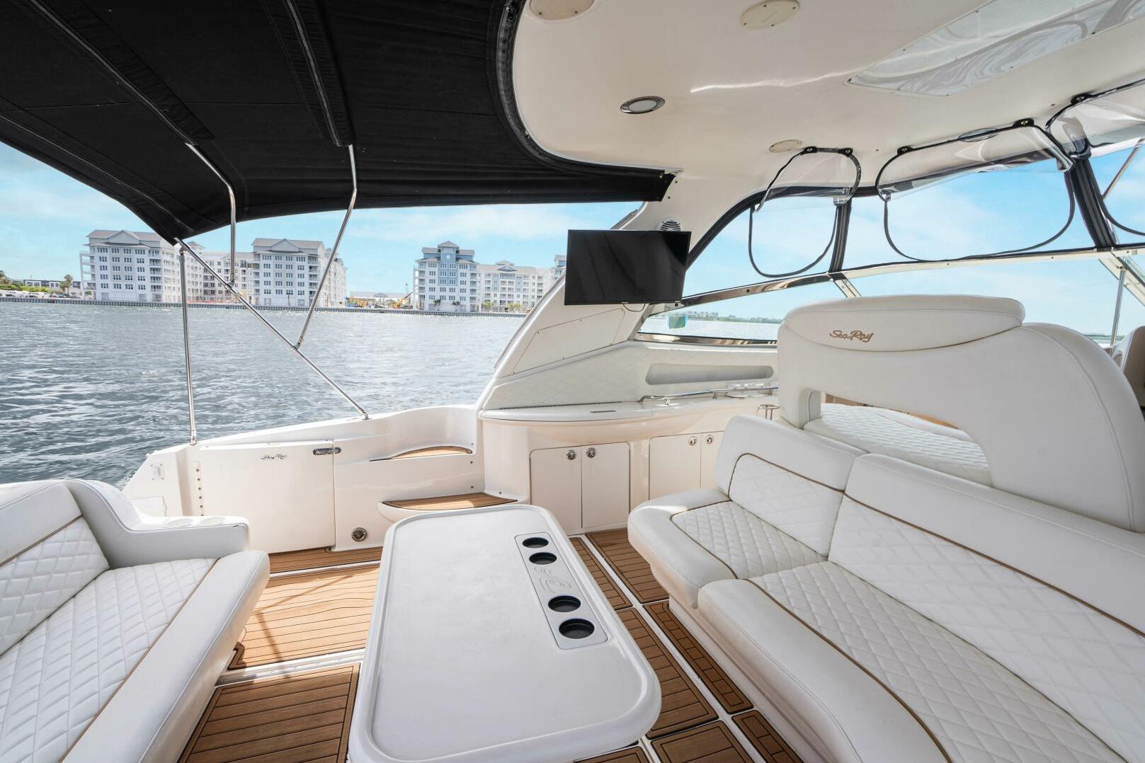 Luxurious 2003 Sea Ray Sundancer 460 yacht interior with elegant seating and waterfront view.