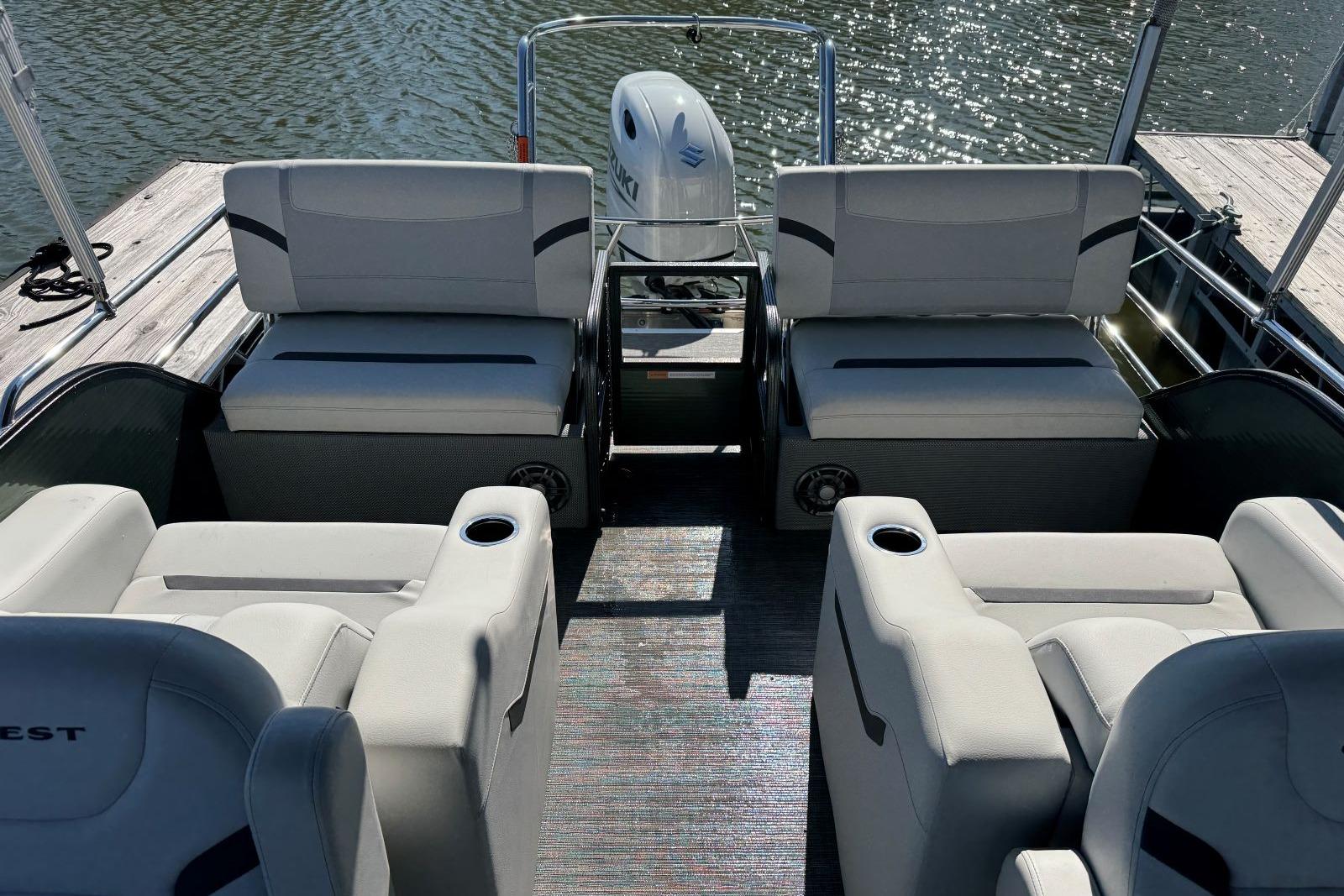 2024 Crest Classic LX 220 SLRC pontoon boat interior with comfortable seating and water view.
