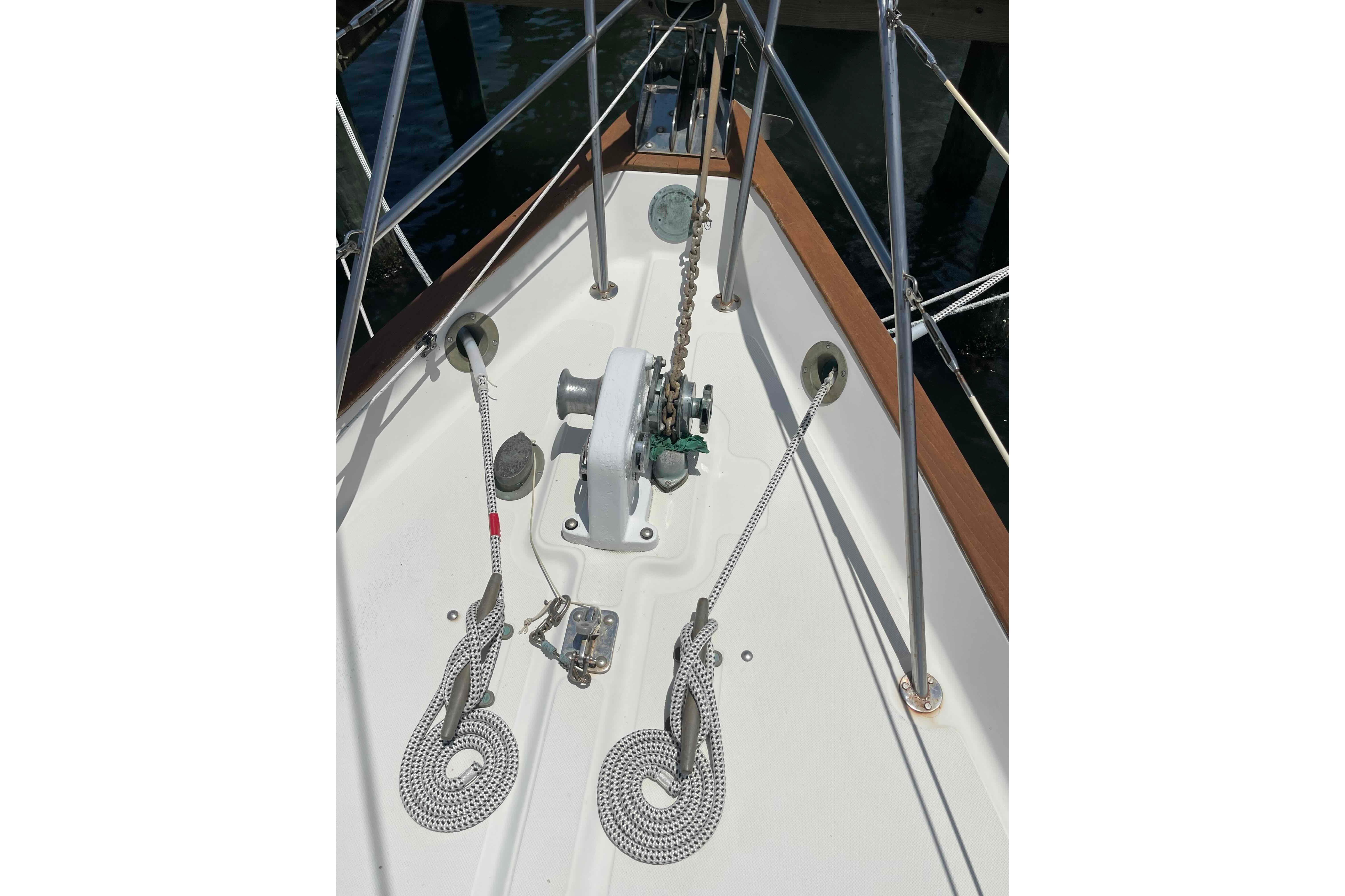 Bow of 1987 Pacific Seacraft 34 sailboat with anchor chain and ropes.