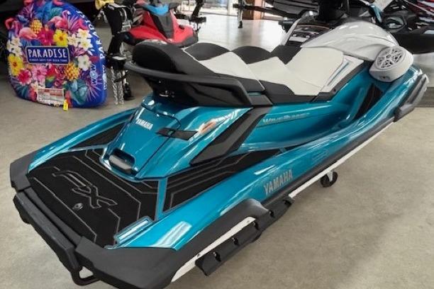 2026 Yamaha WaveRunner FX Cruiser HO in showroom, vibrant blue and black design.