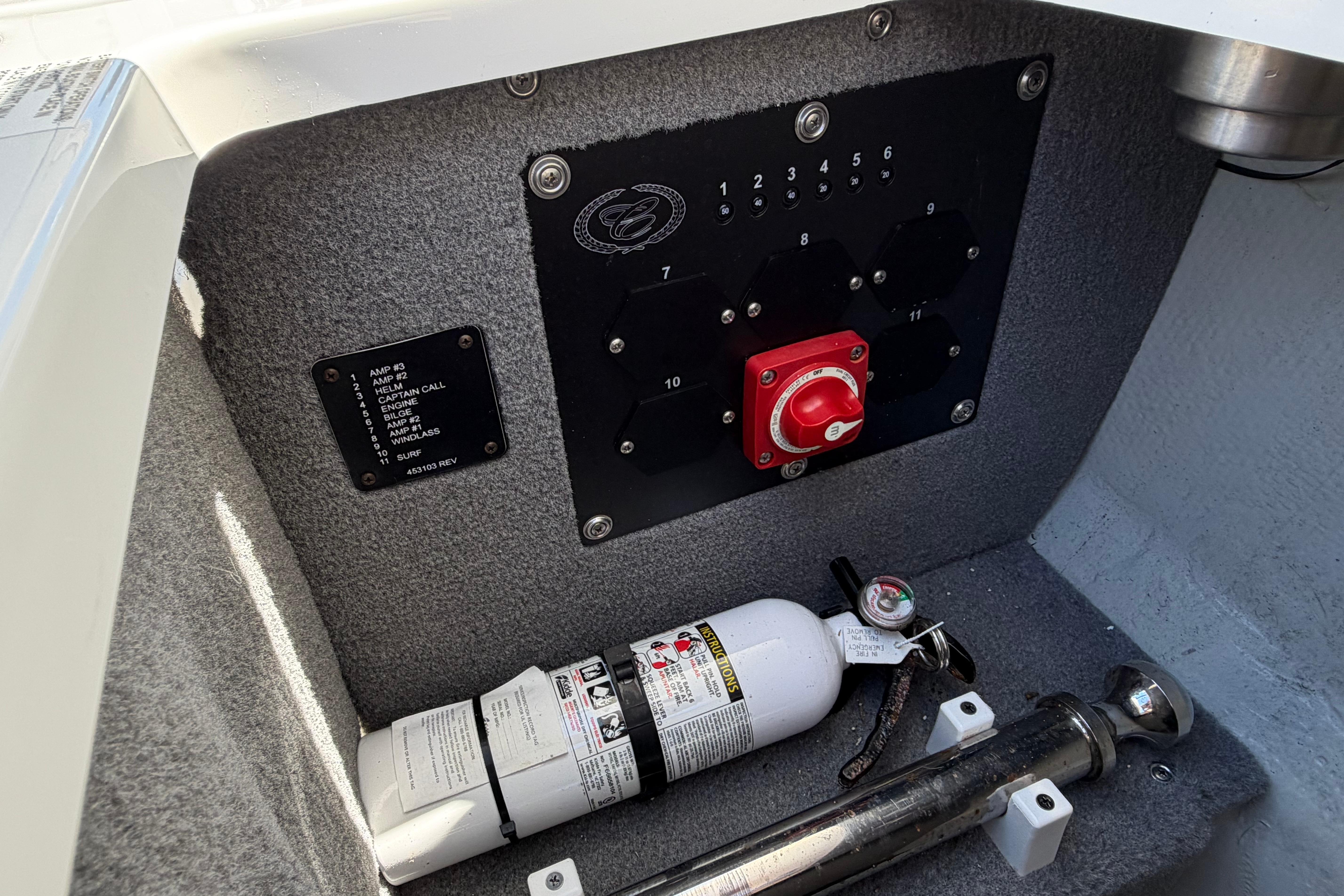 Control panel and fire extinguisher in 2020 Cobalt R3 boat interior.
