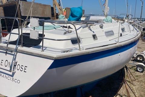1988 Westerly Corsair 36 sailboat docked, featuring a white and blue hull.