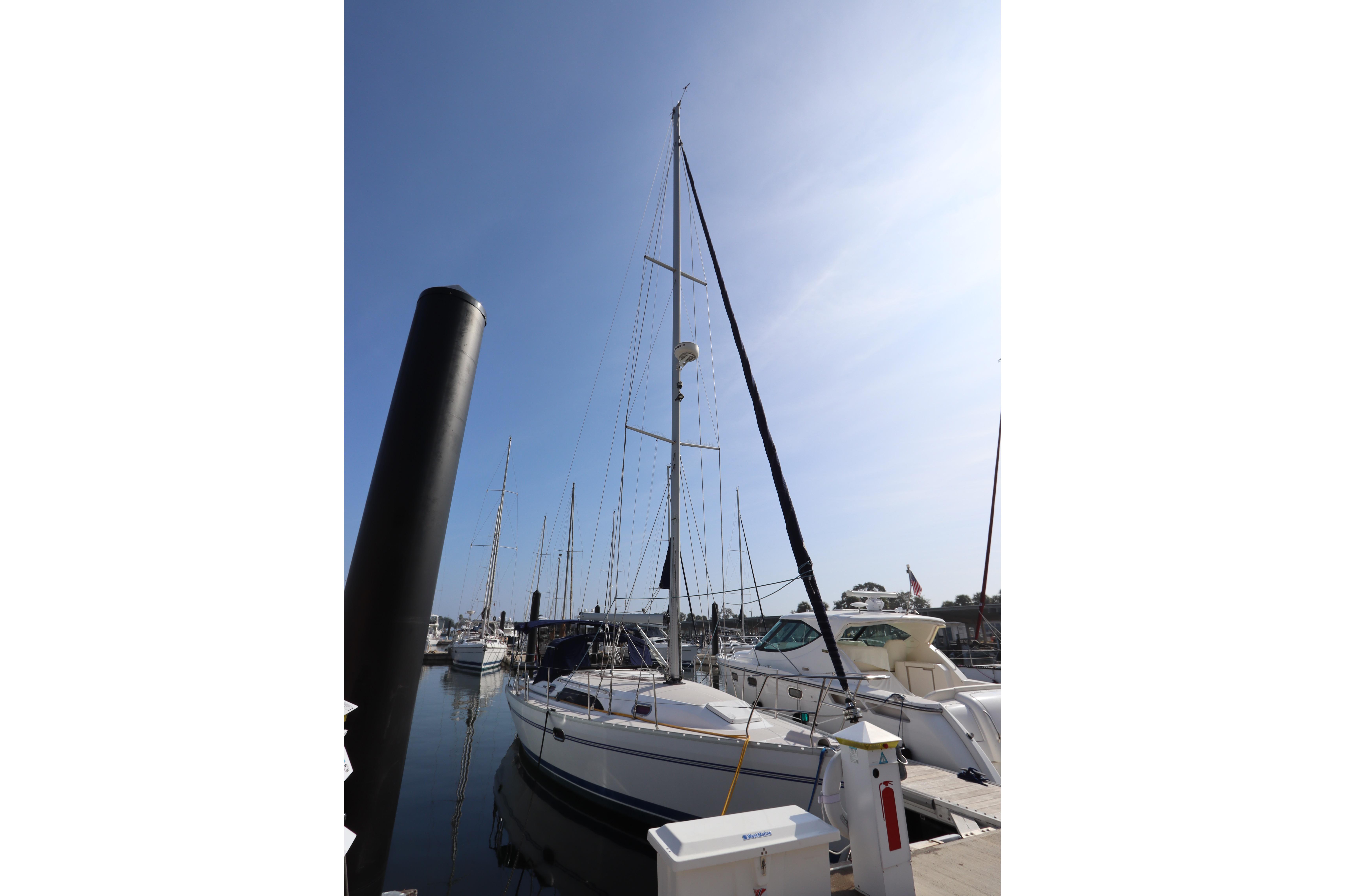 2011 Catalina 355 sailboat docked at marina under clear blue sky.