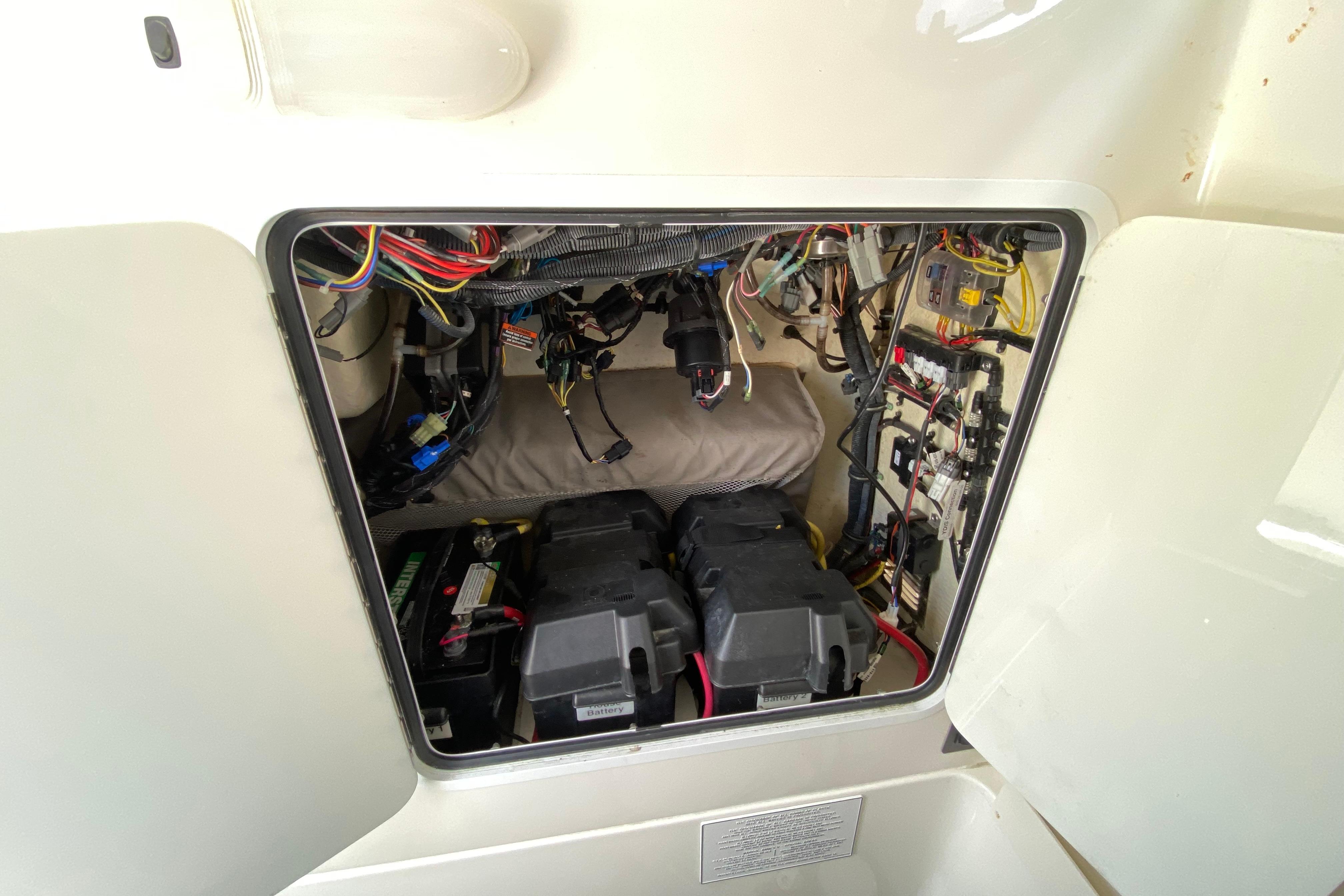 2021 Regulator 28 boat electrical compartment with wiring and battery setup.