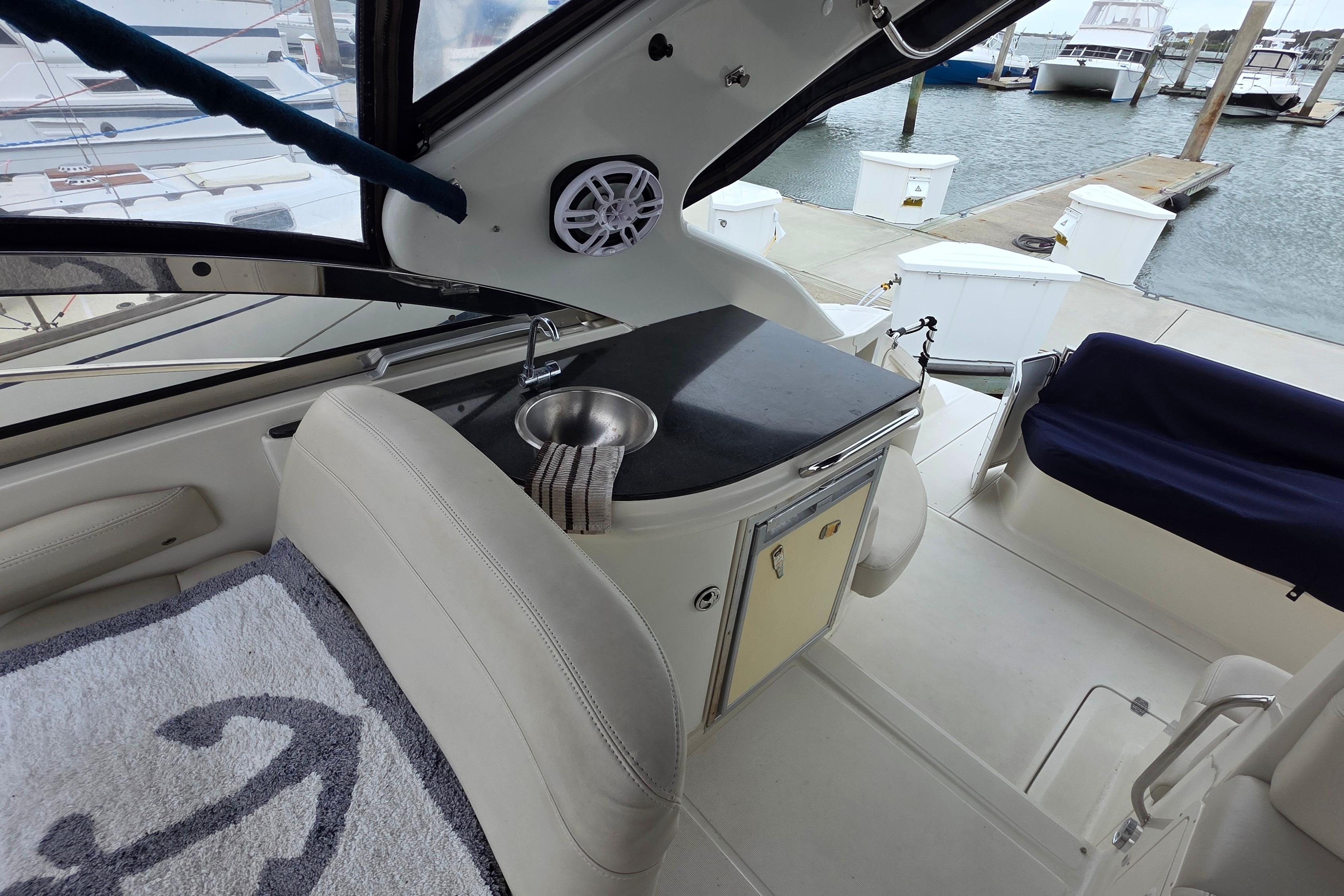 Interior of a 2002 Regal Commodore 4260 yacht with sink and seating area.