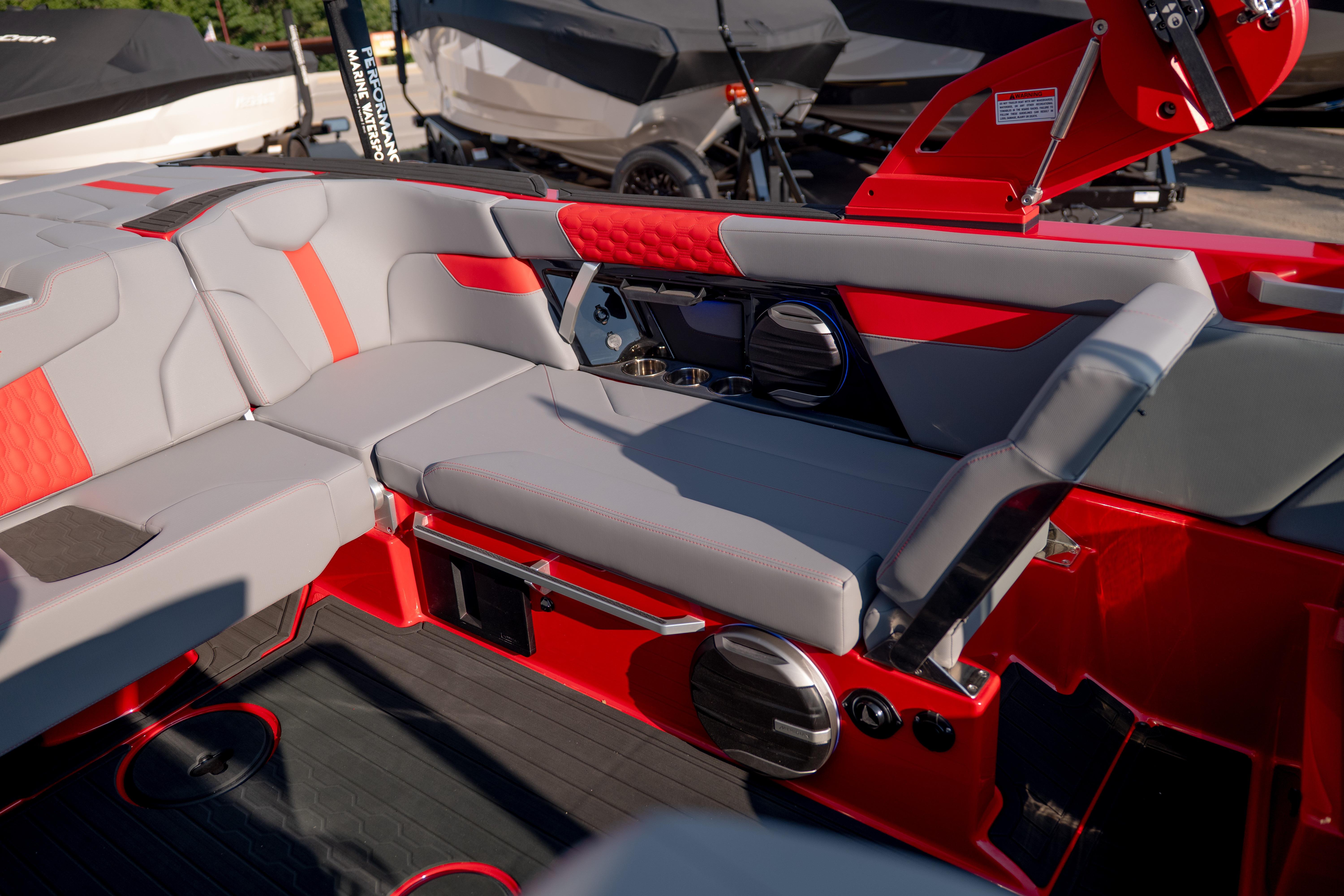 Interior of 2027 MasterCraft XT24 boat with red and gray seating and modern design.